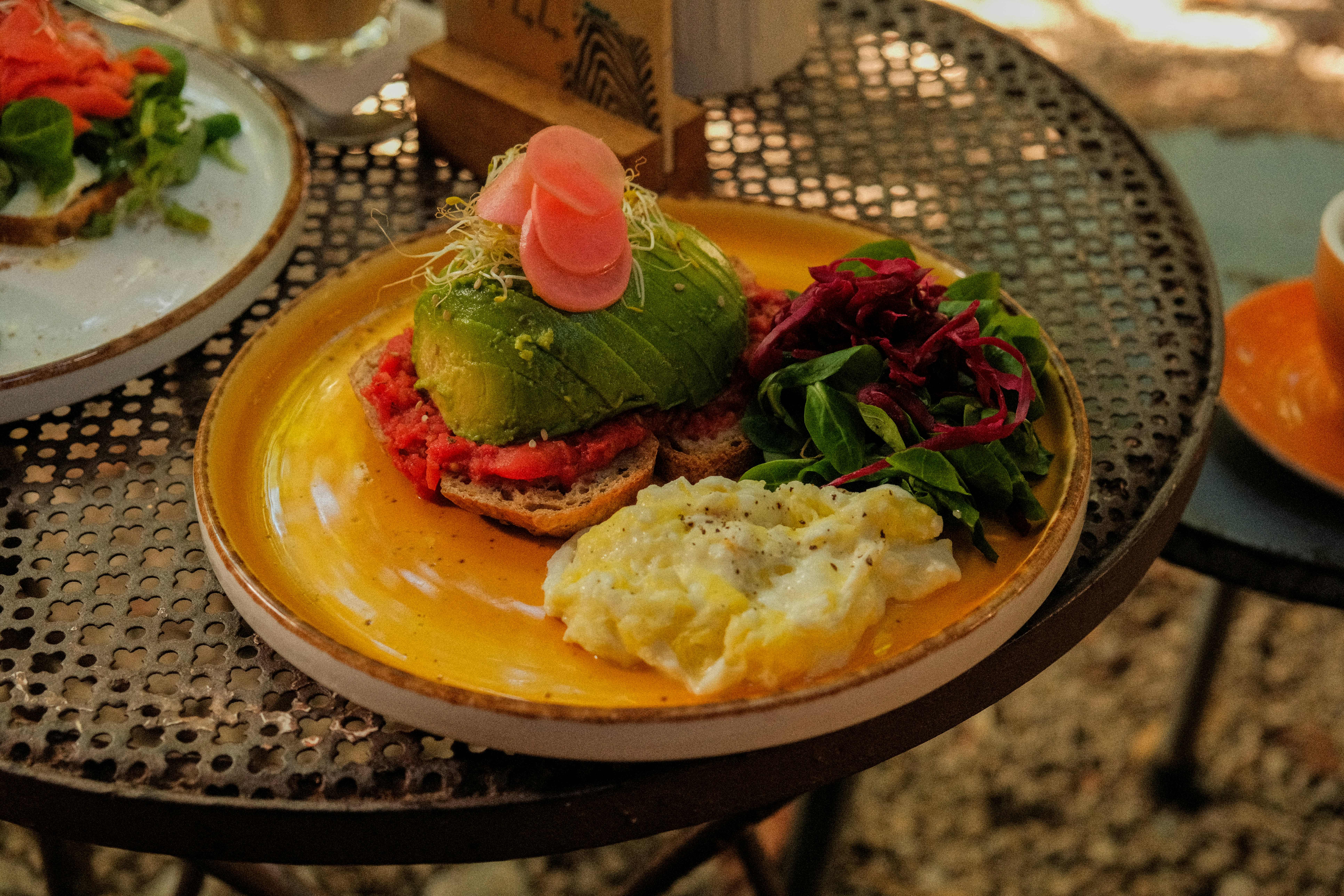 various avocado toast toppings like radish, tomato, and seeds - healthy breakfast with avocado