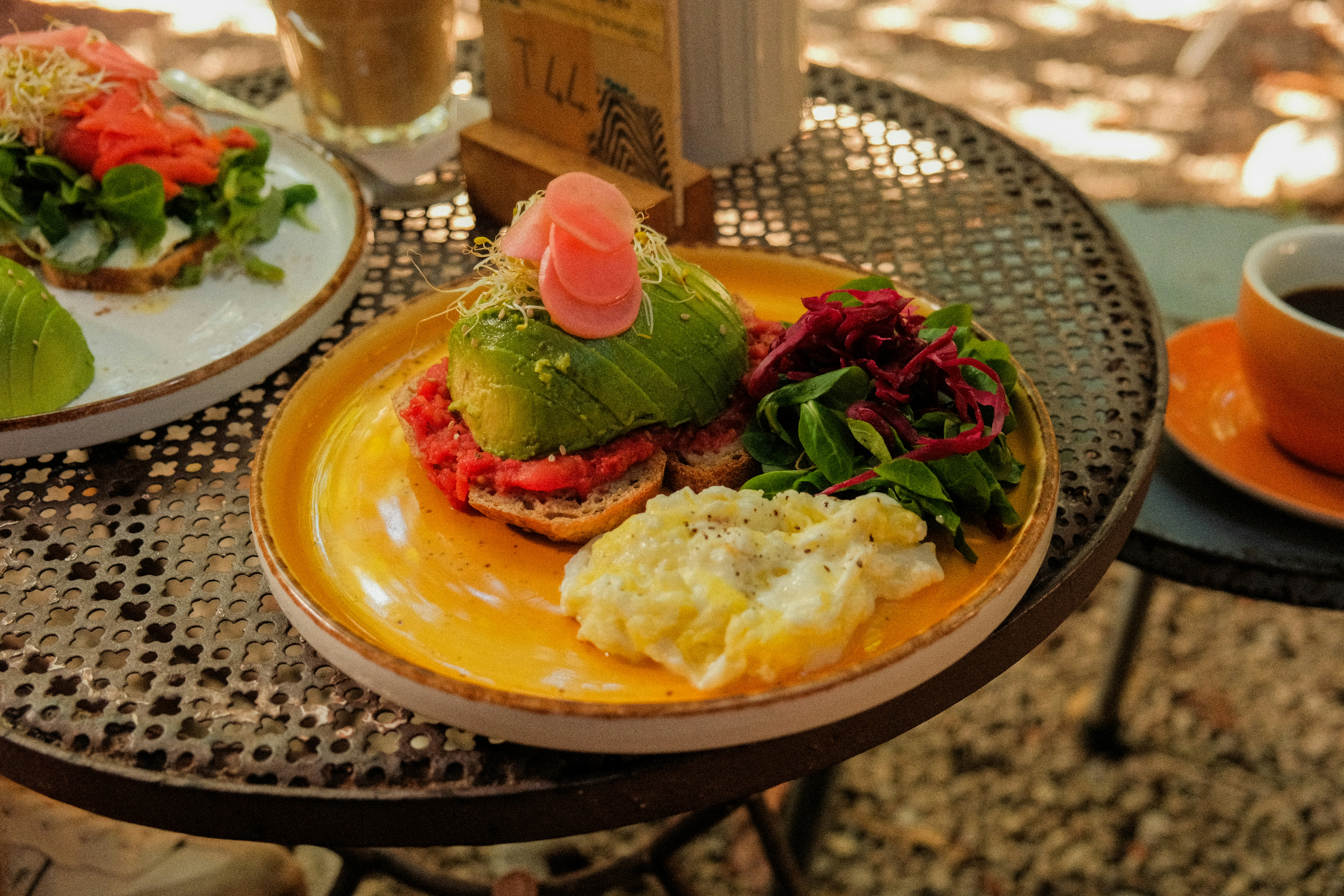 Avocado toast with side salad and scrambled eggs