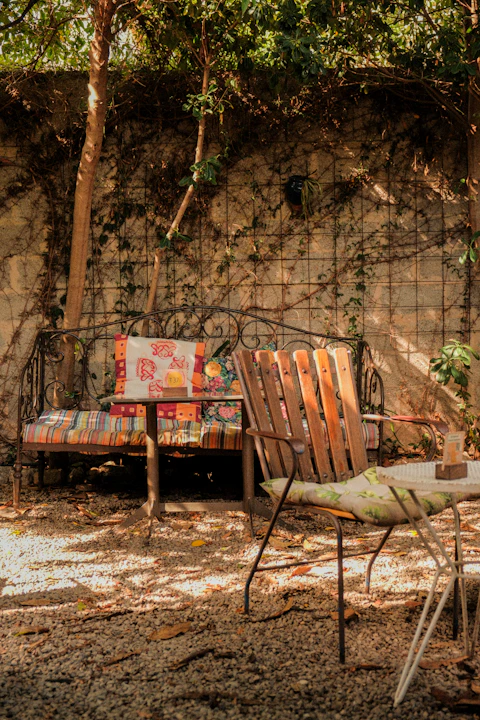 Outdoor seating area with a bench and chairs.
