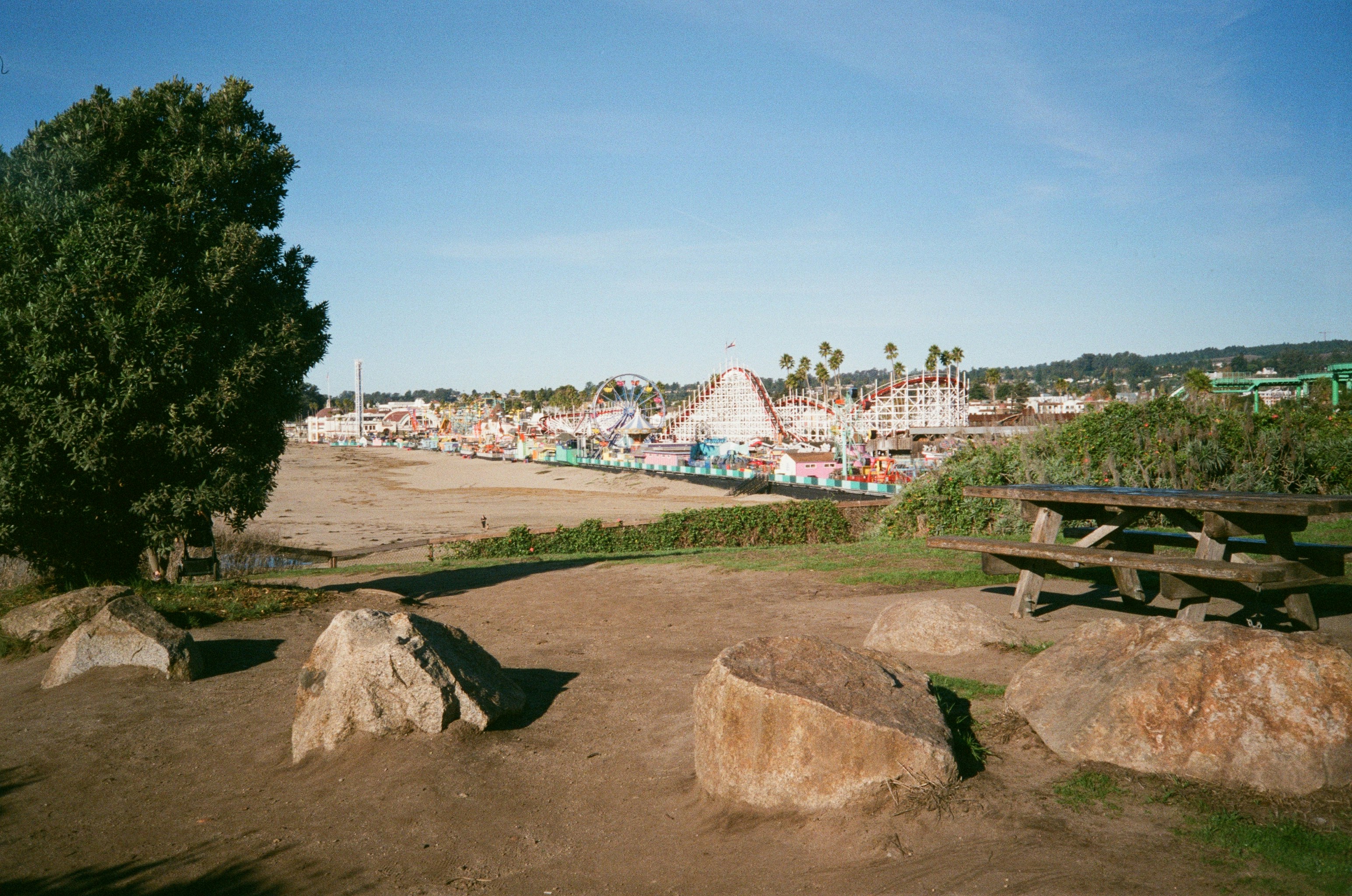 Amusement park rides and attractions seen from a park area.