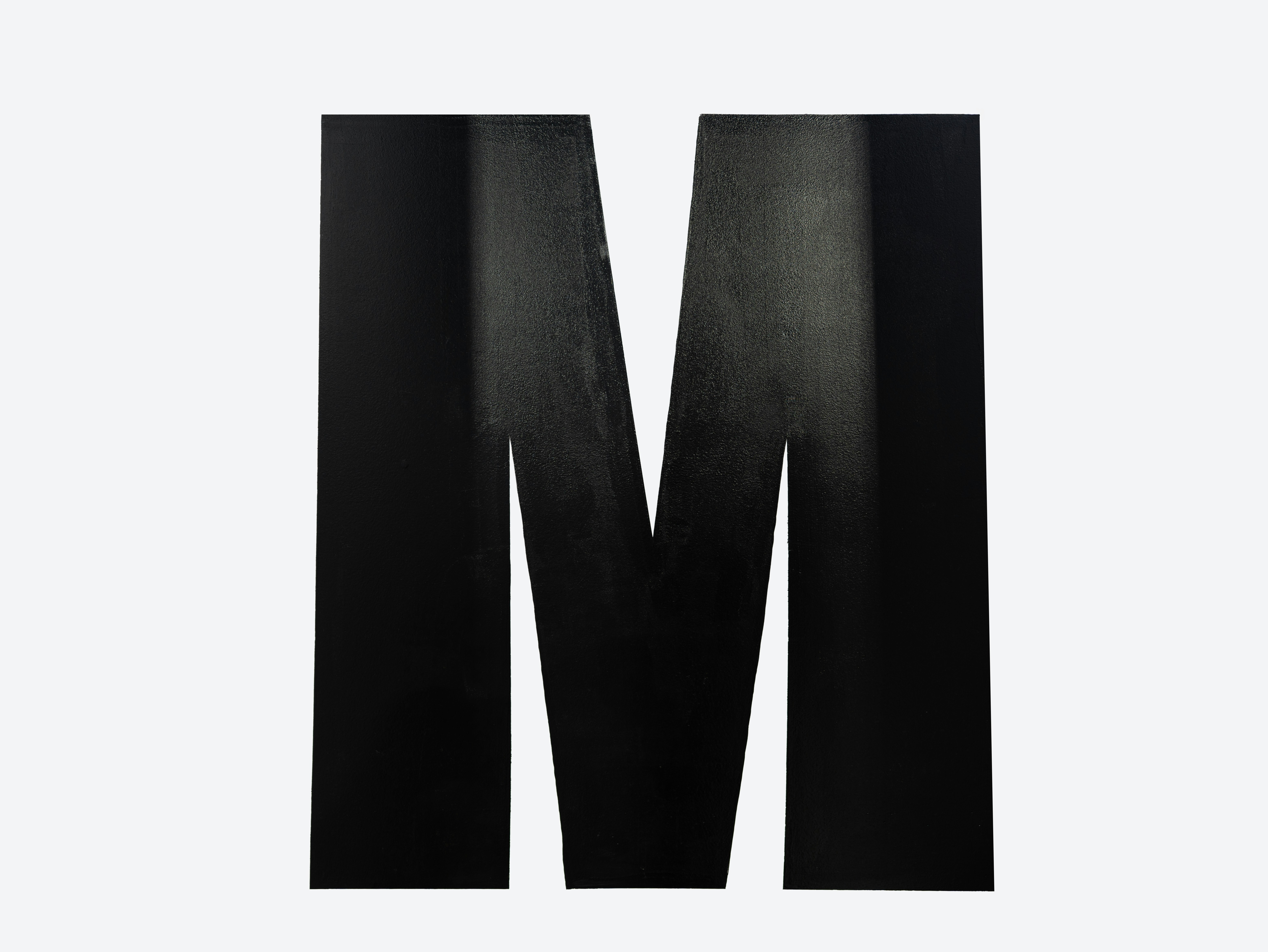A large black letter m on a white background