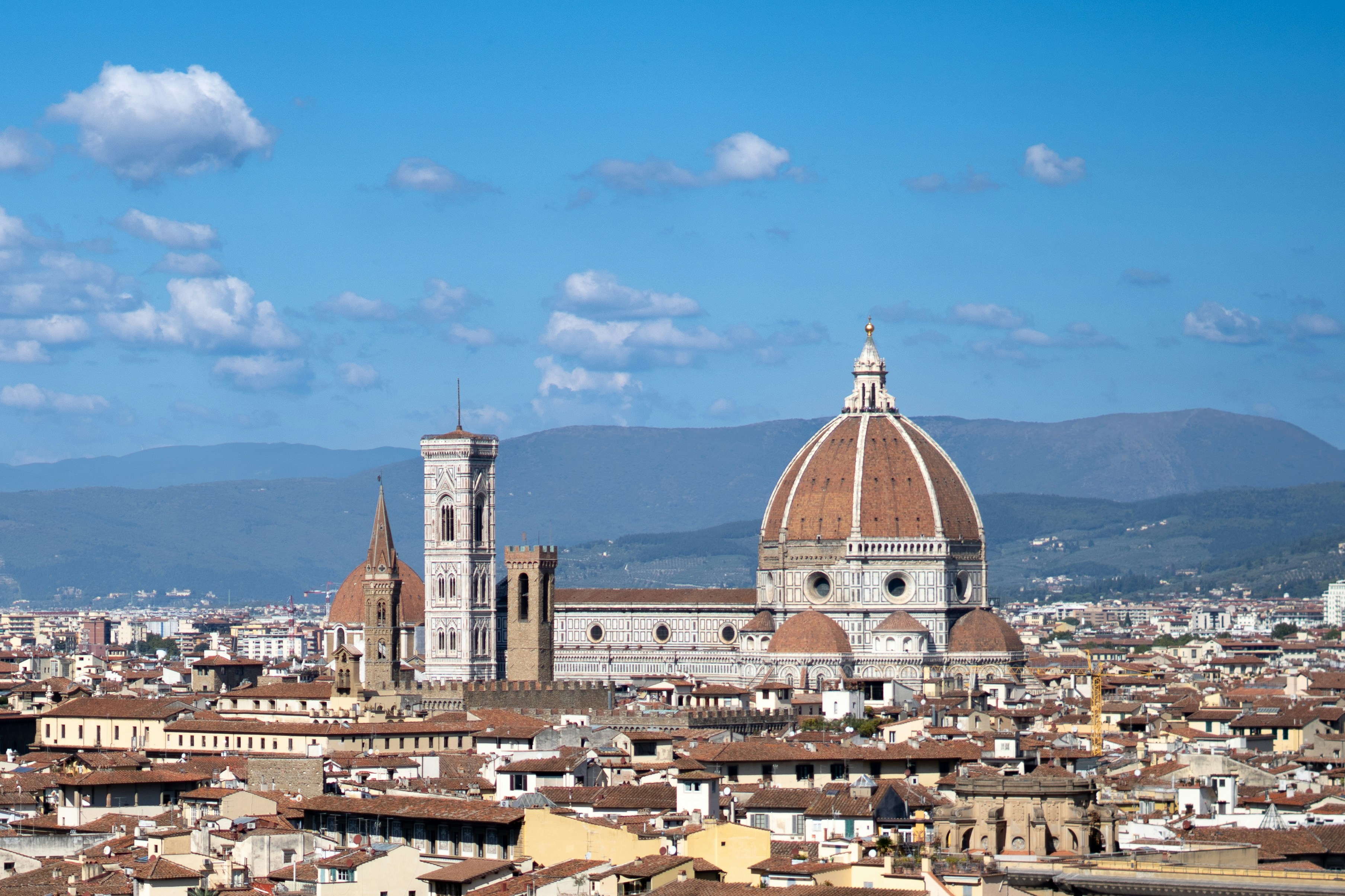 Florence cityscape with the duomo cathedral under blue sky.