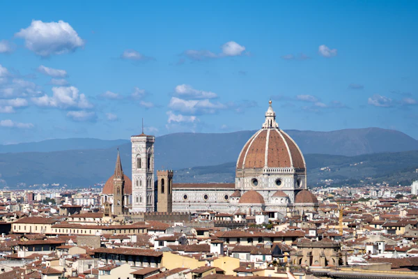 Florence's cathedral dome and rooftops beneath a blue sky
