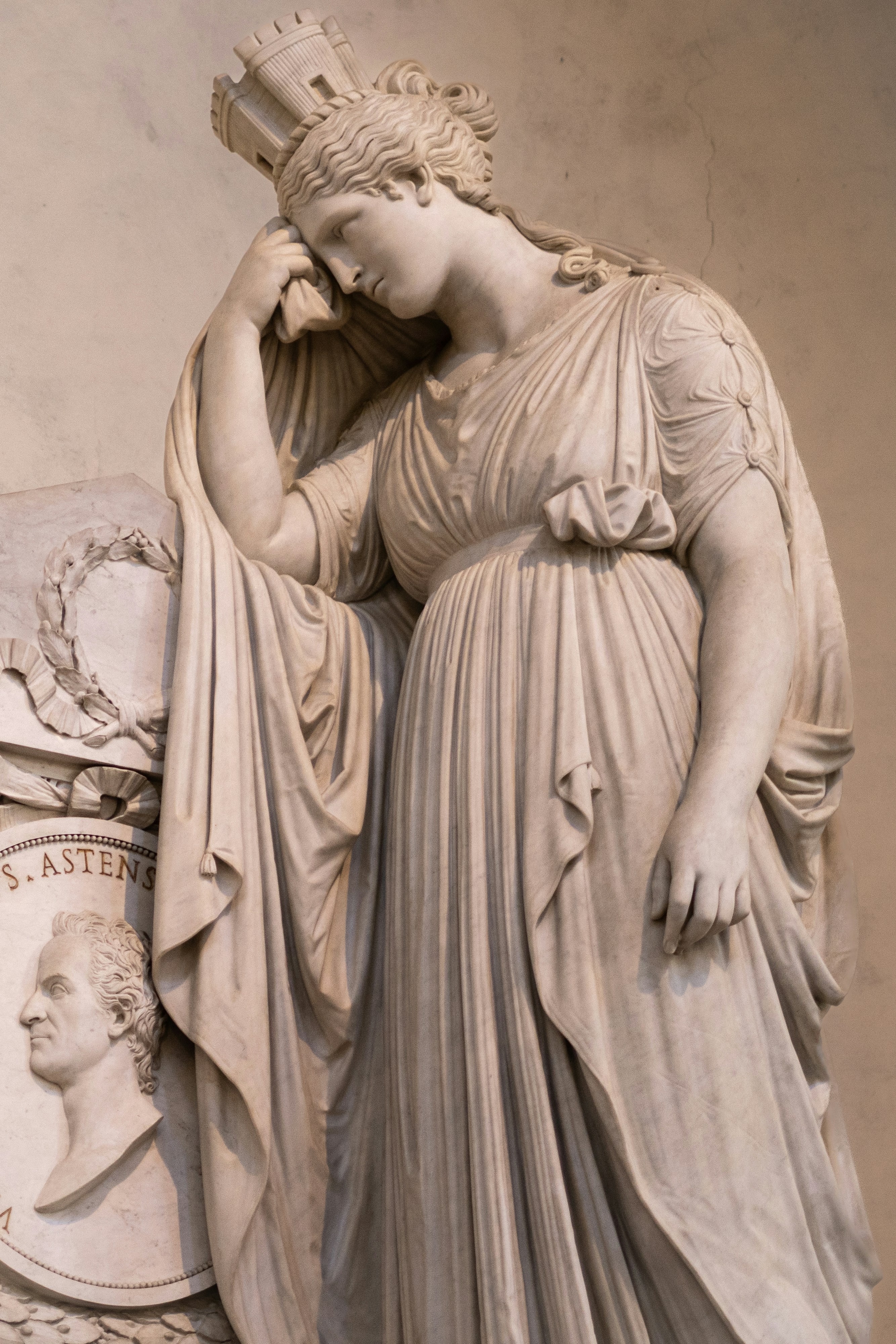 Marble statue of a crowned woman in a draped gown.