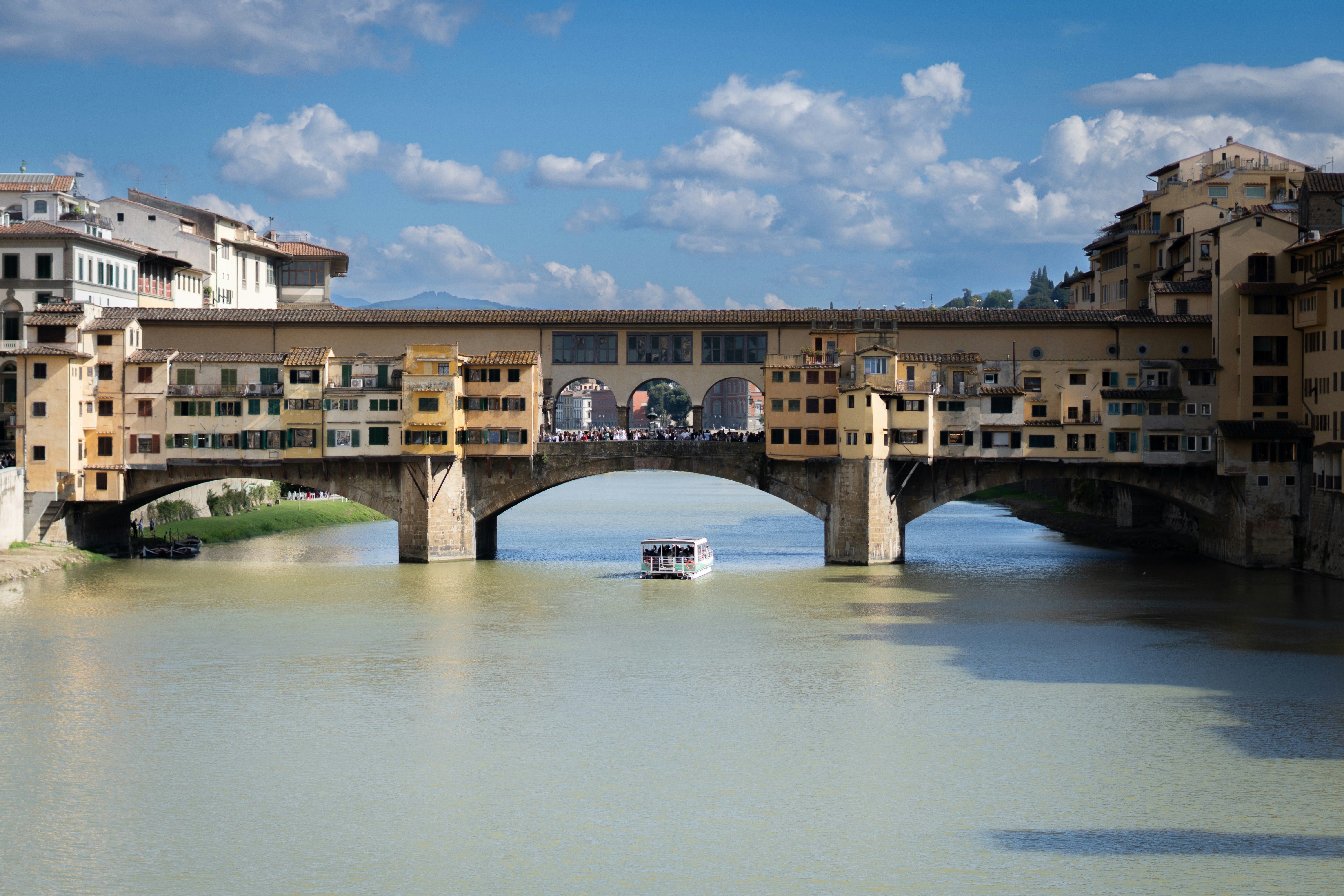 Ponte vecchio bridge with arno river and boat