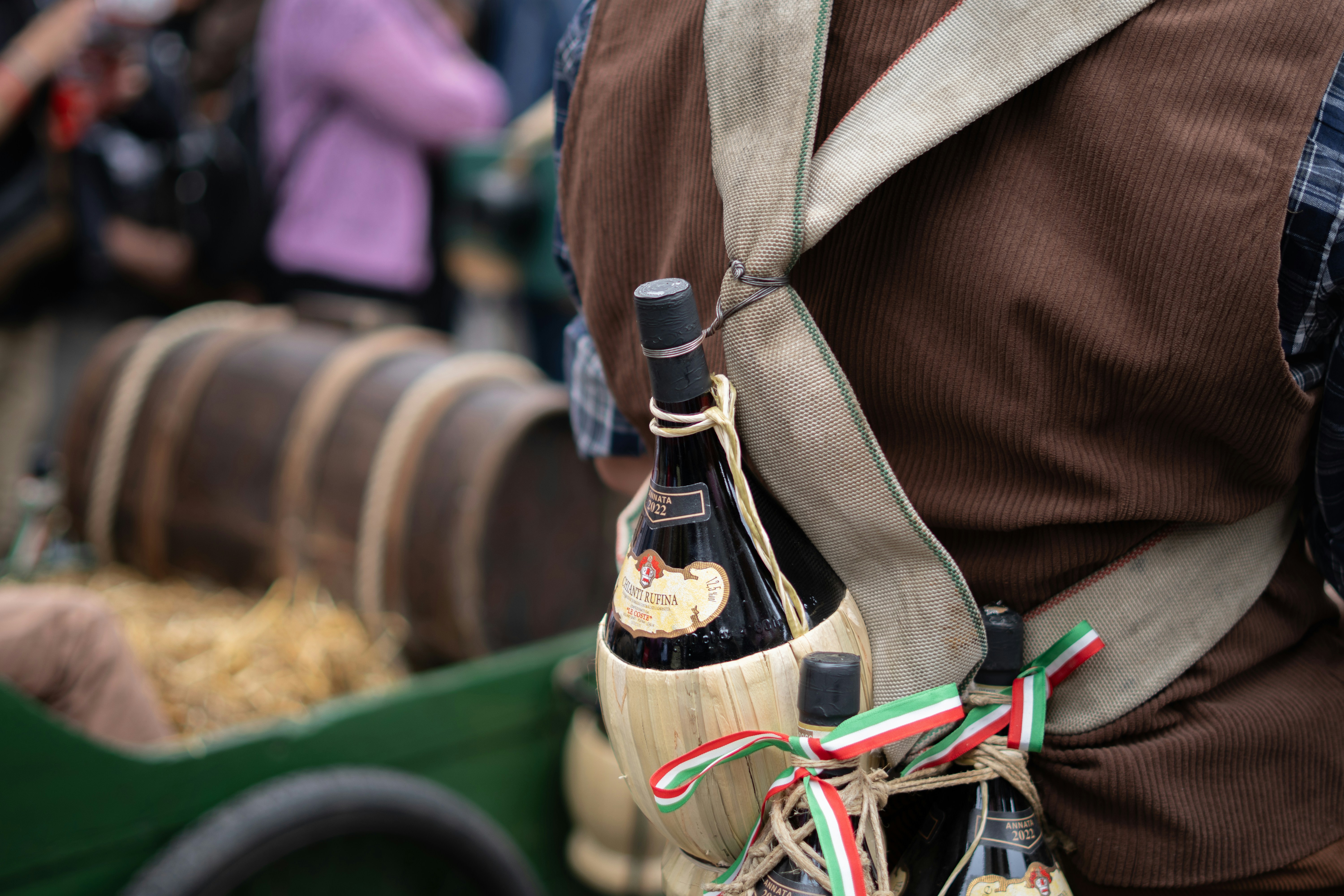 Bottles of wine secured to a person's vest