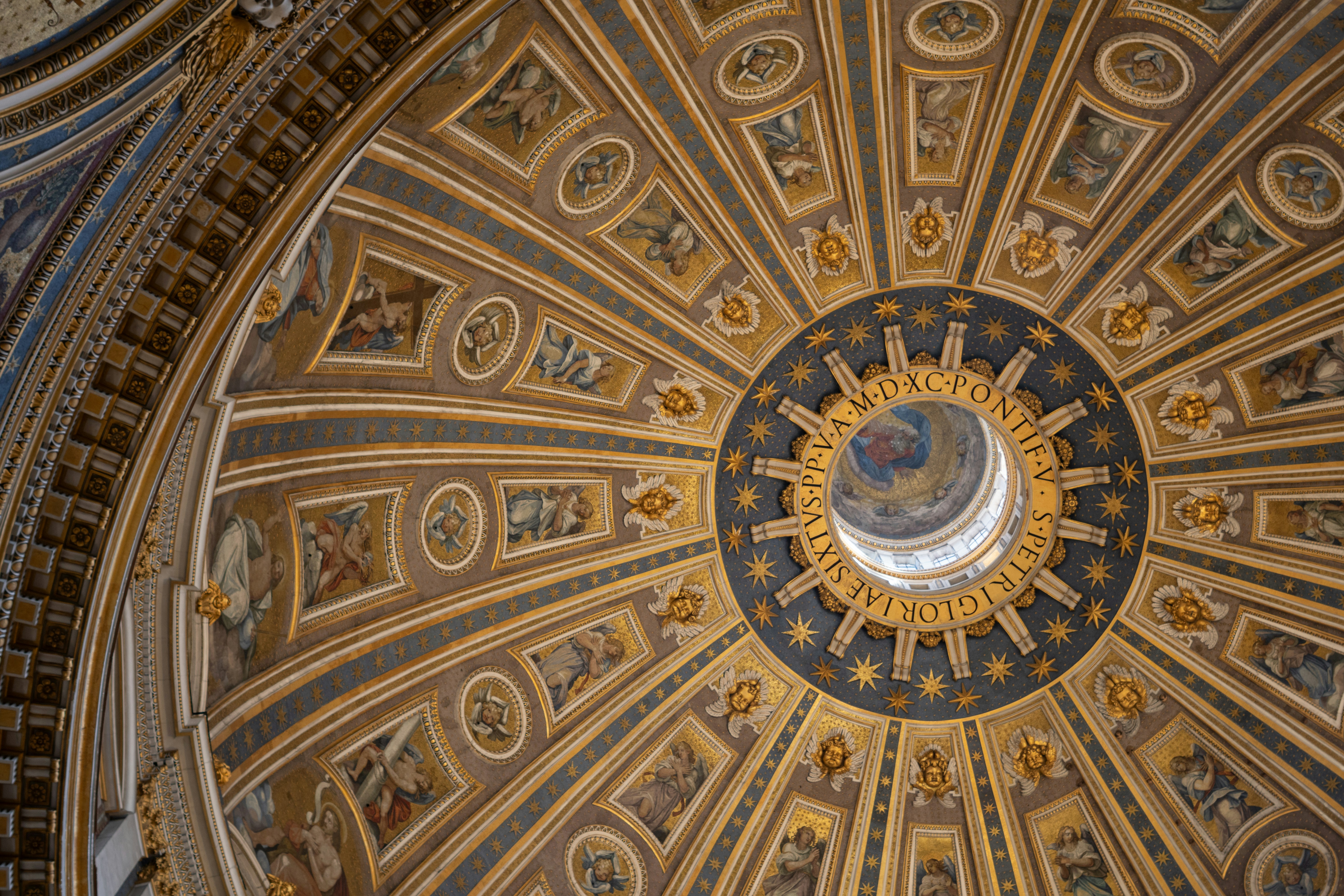 Intricate dome ceiling with ornate patterns and a central opening.