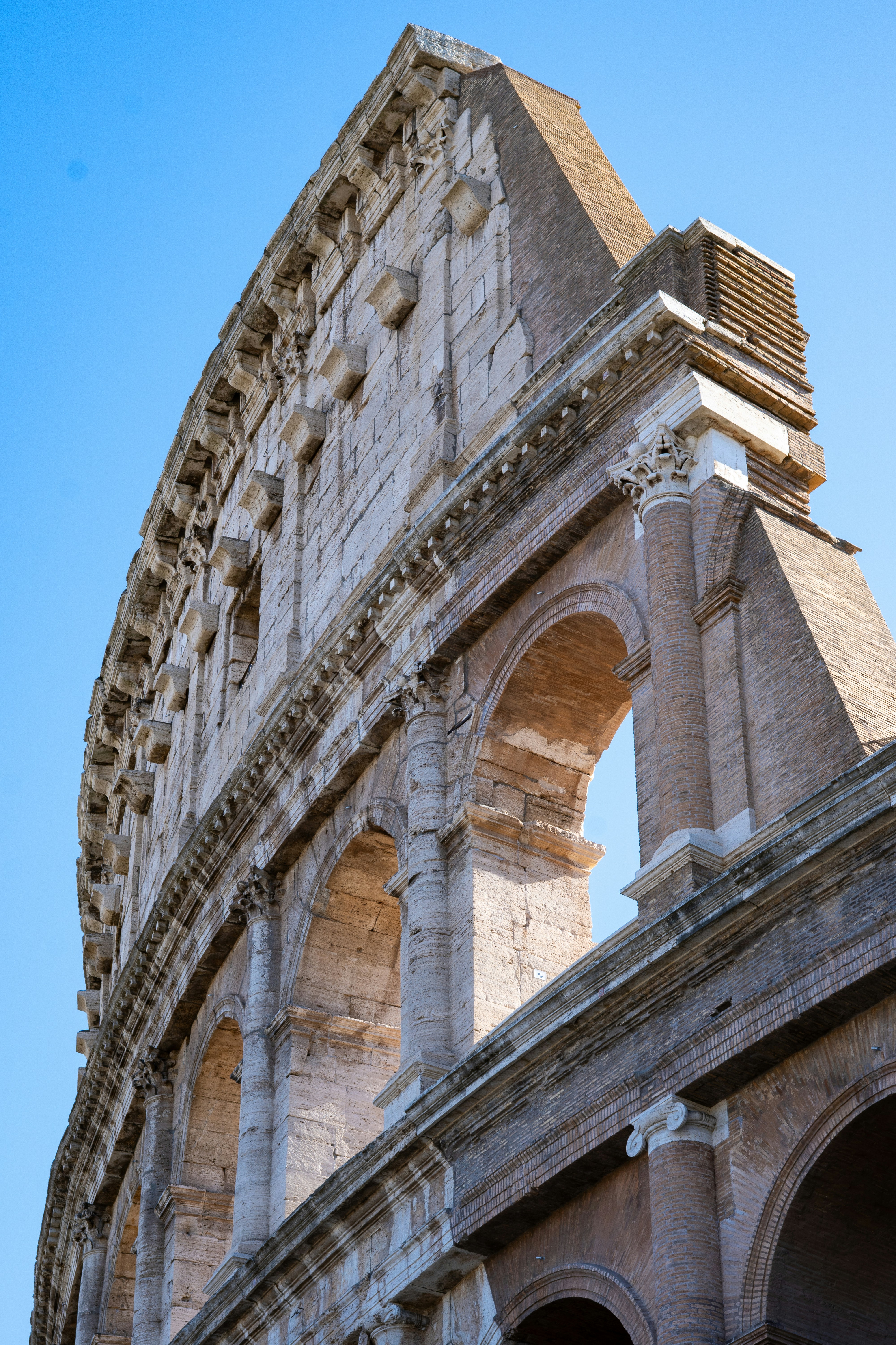The colosseum in rome under a clear blue sky
