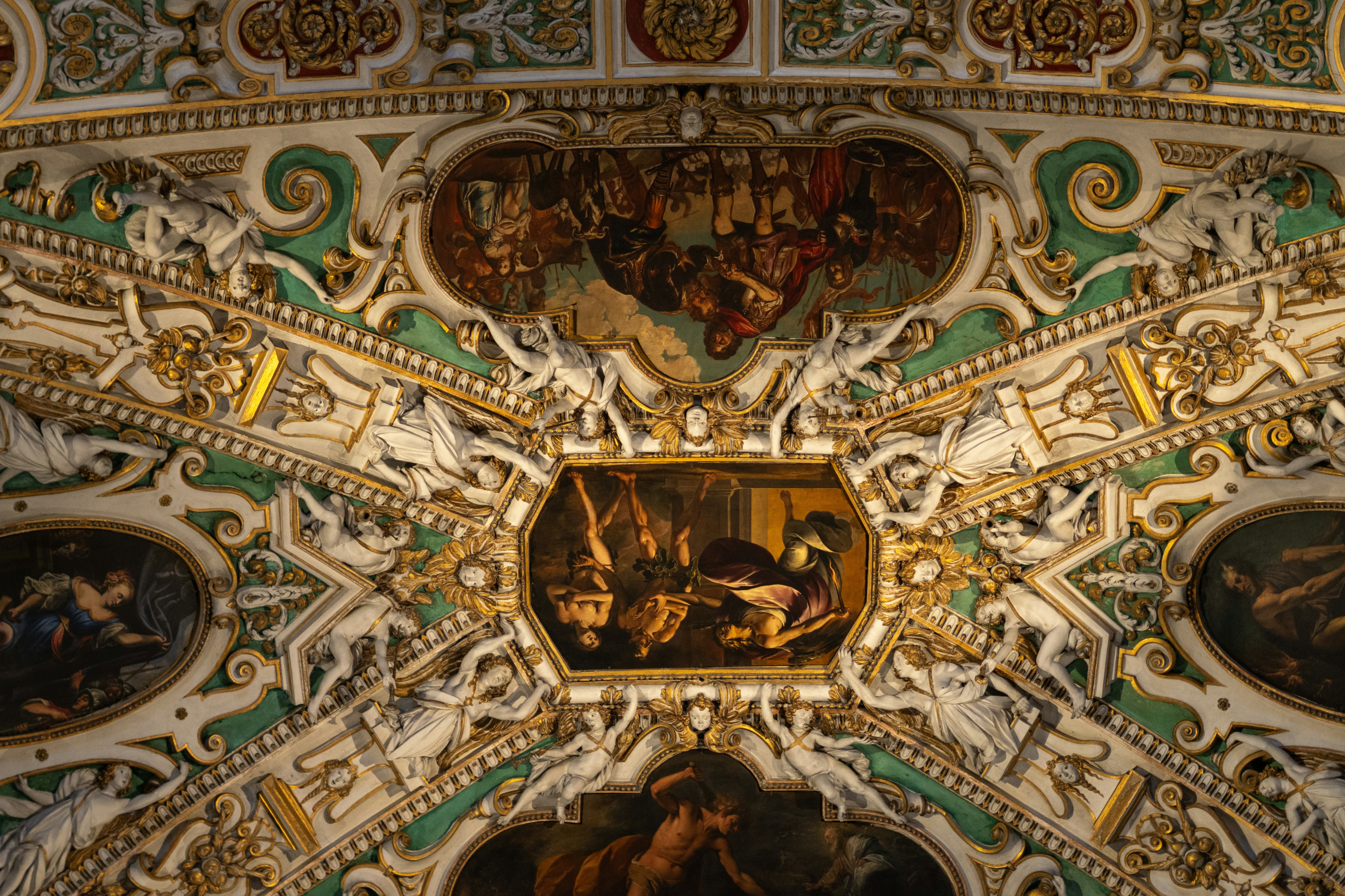 Ornate ceiling with paintings and intricate stucco work