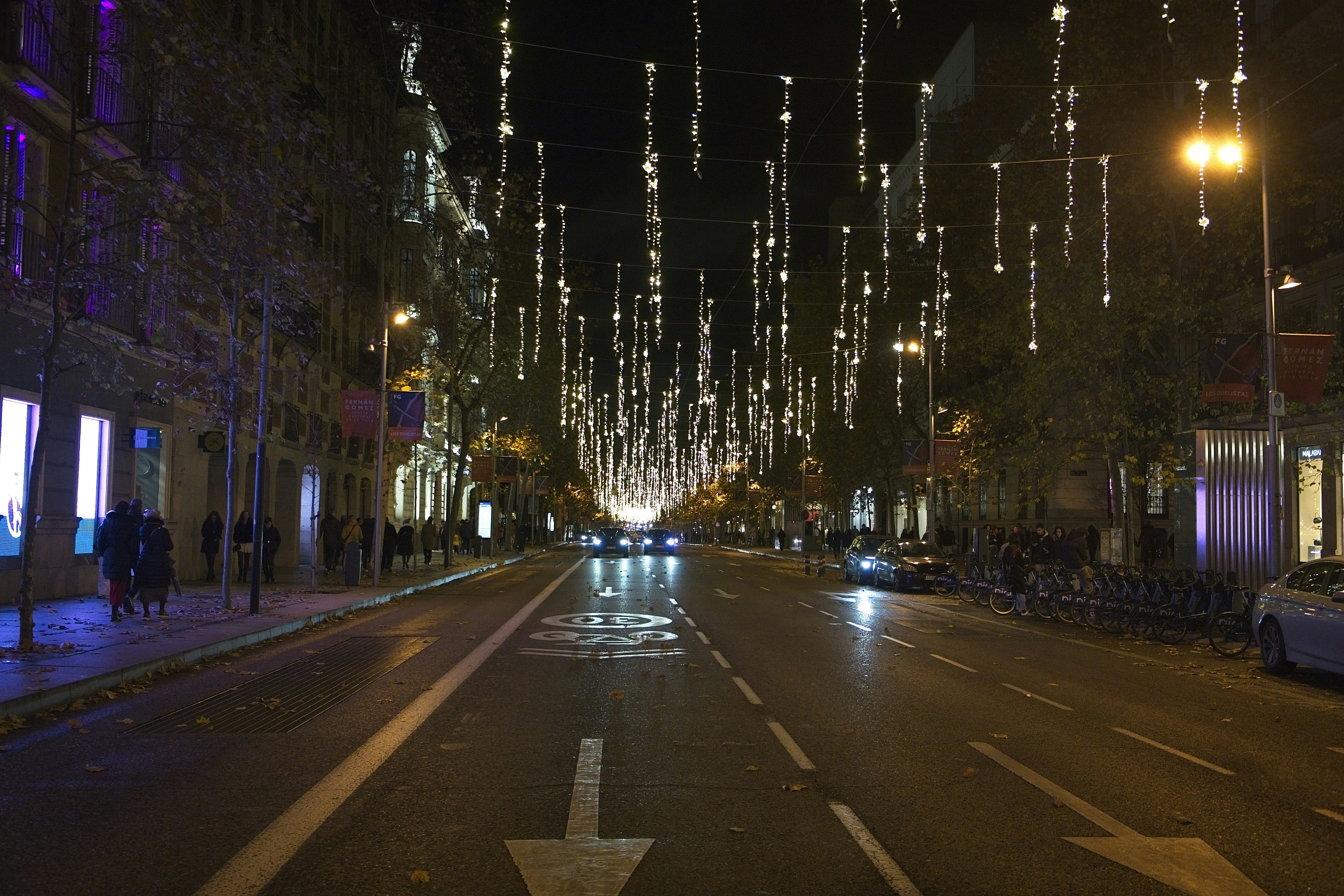 Street decorated with festive lights at night