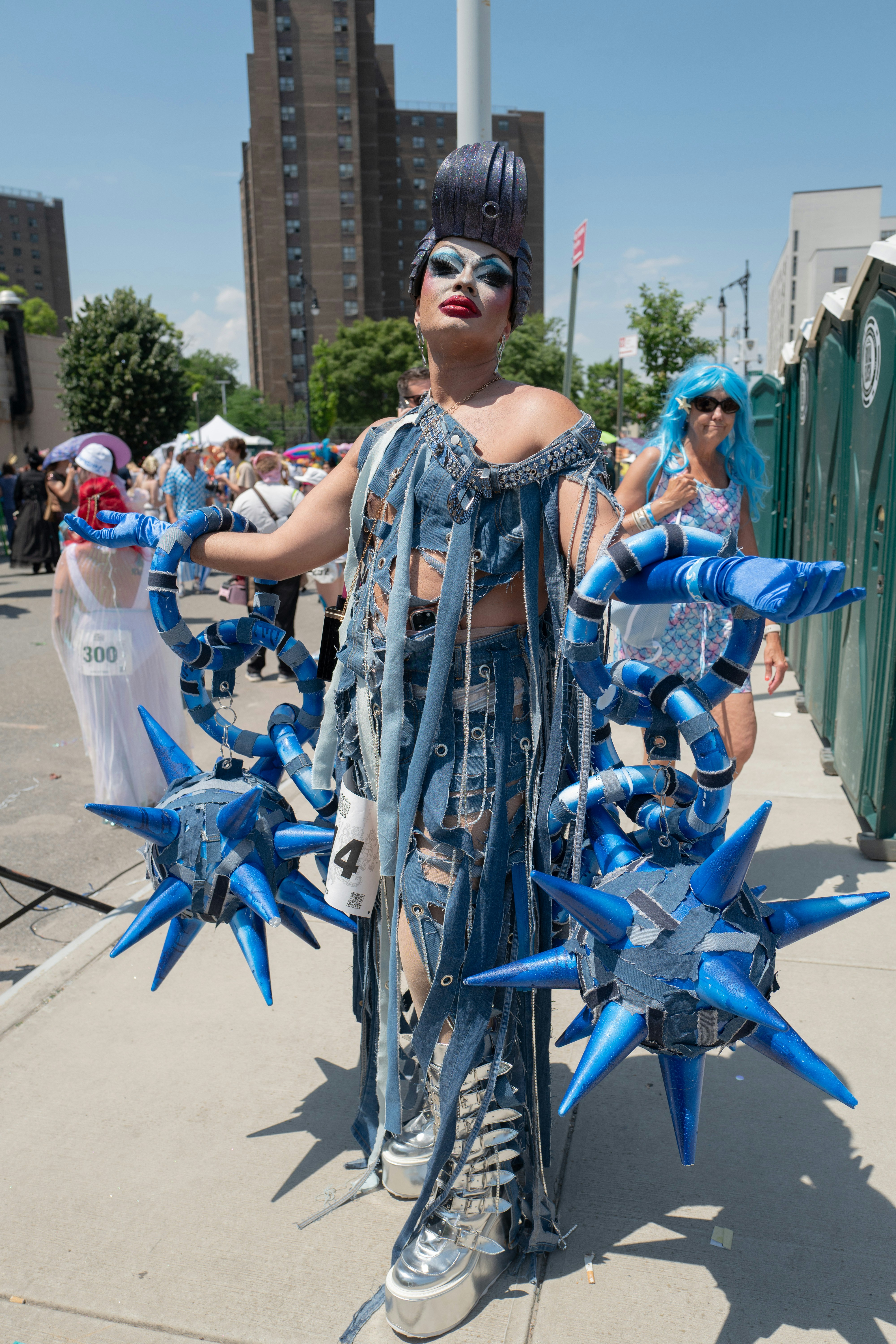 Drag queen in denim outfit with spiked accessories