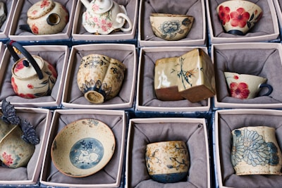 Collection of decorative ceramic tea cups and pots.