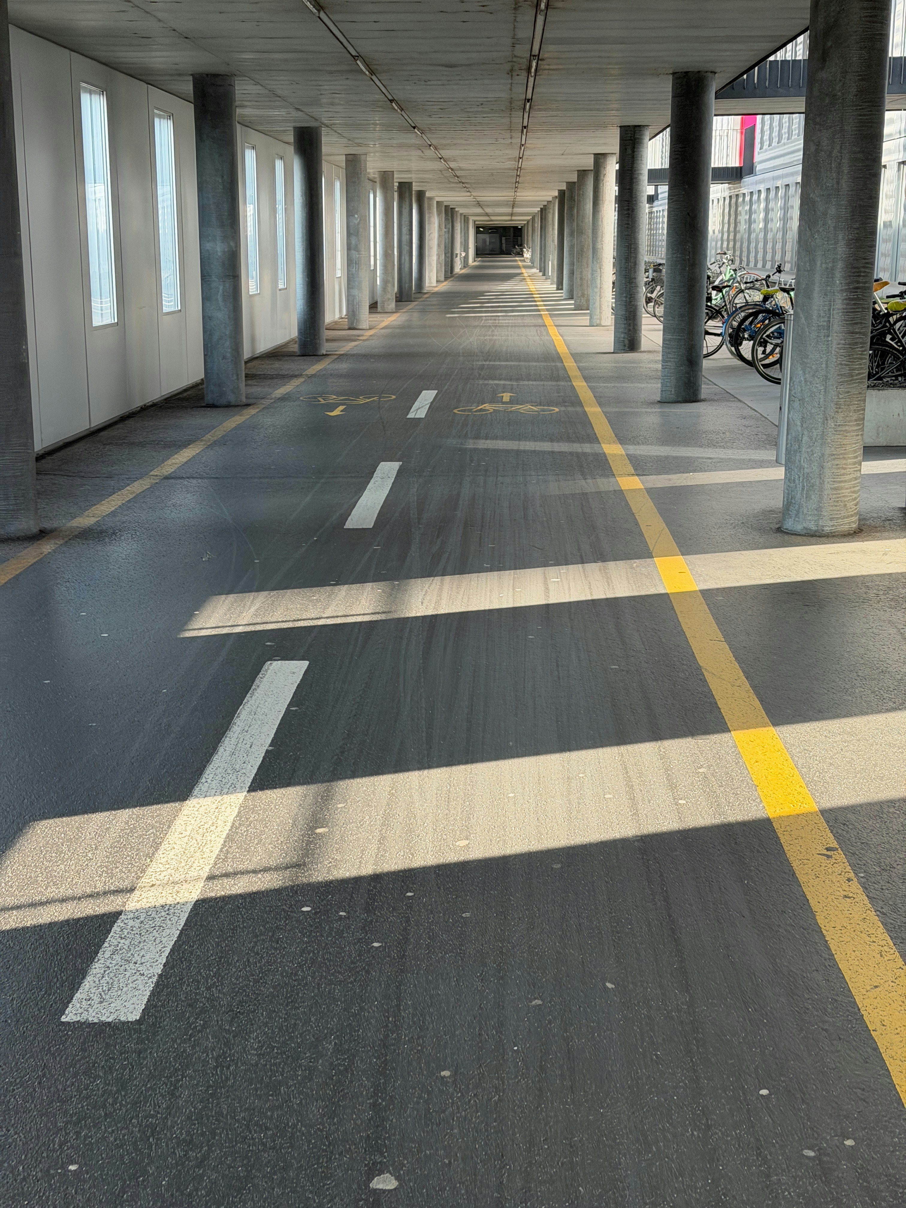 Long covered walkway with painted lines and columns