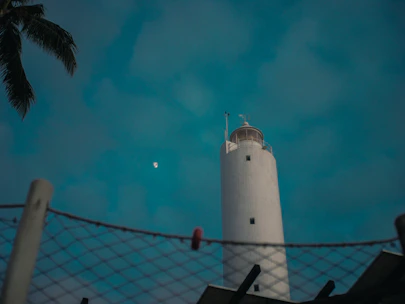 White lighthouse against a bright blue sky