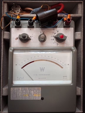 Vintage electrical meter with analog dial and knobs