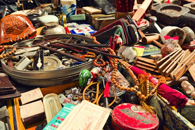 A cluttered collection of various antique objects and trinkets