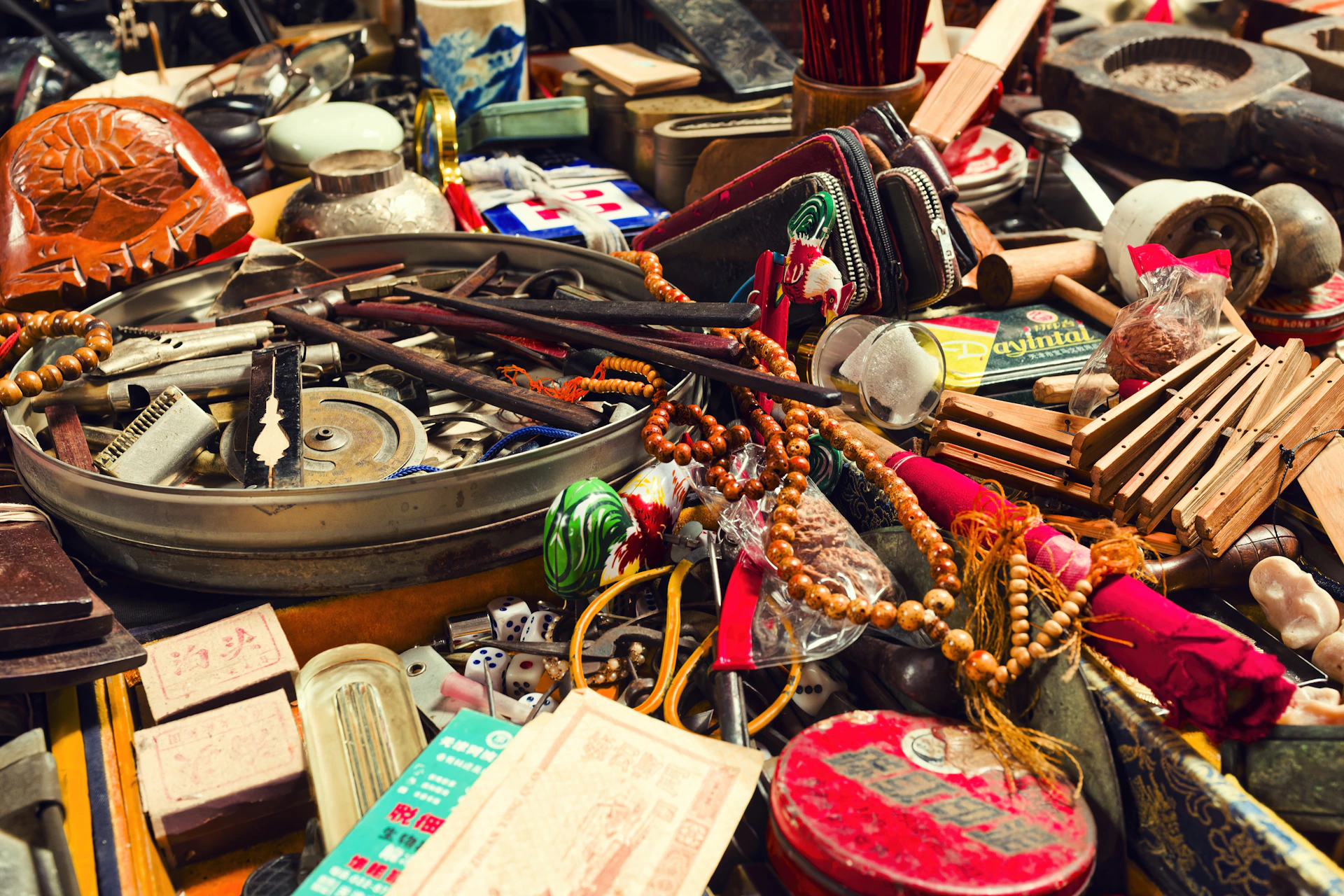 A cluttered collection of various antique objects and trinkets.