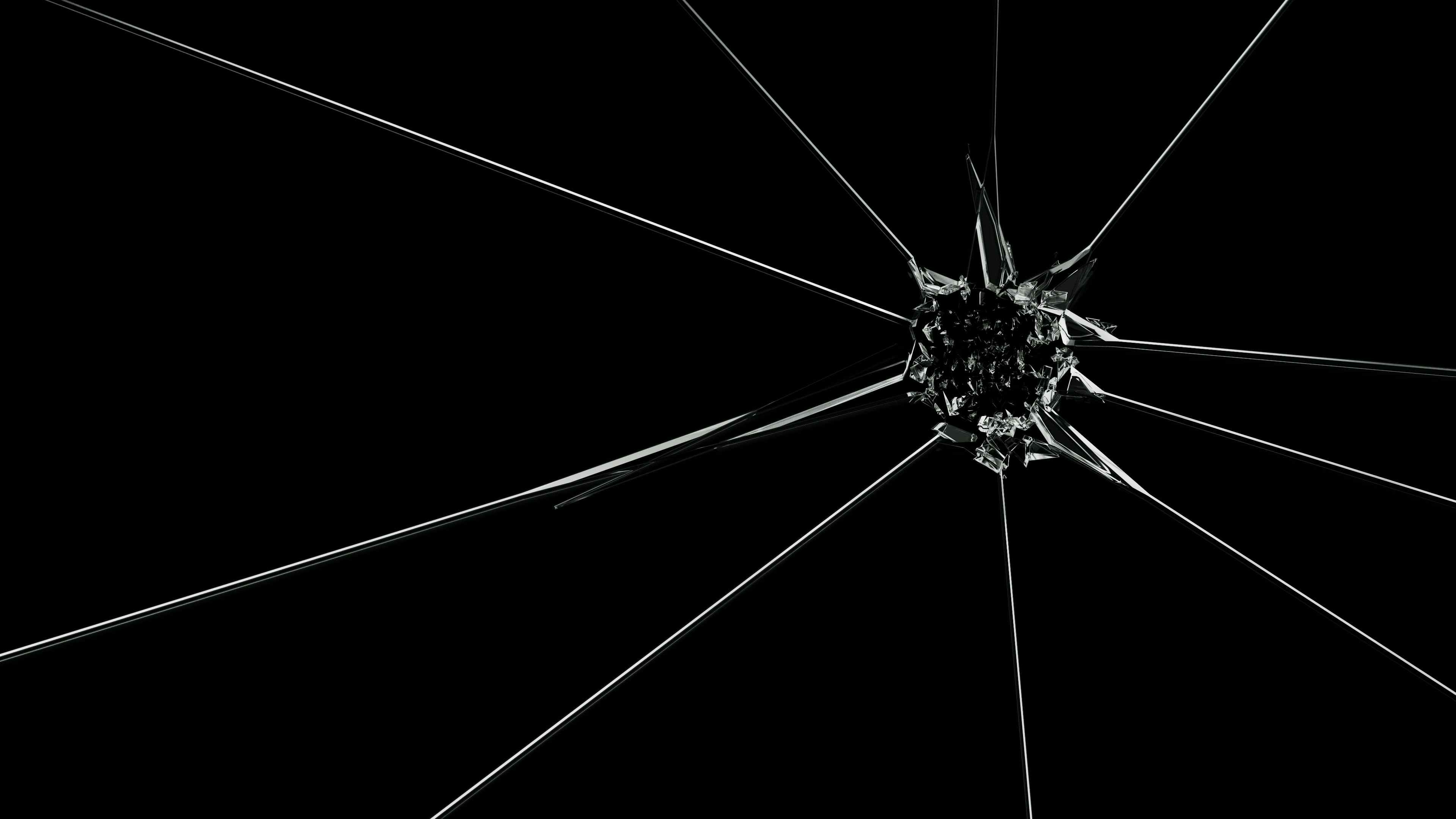 Cracked glass with radiating lines on black