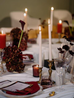 A beautifully set table with candles and flowers.