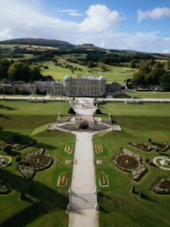 Grand estate with manicured gardens and rolling hills