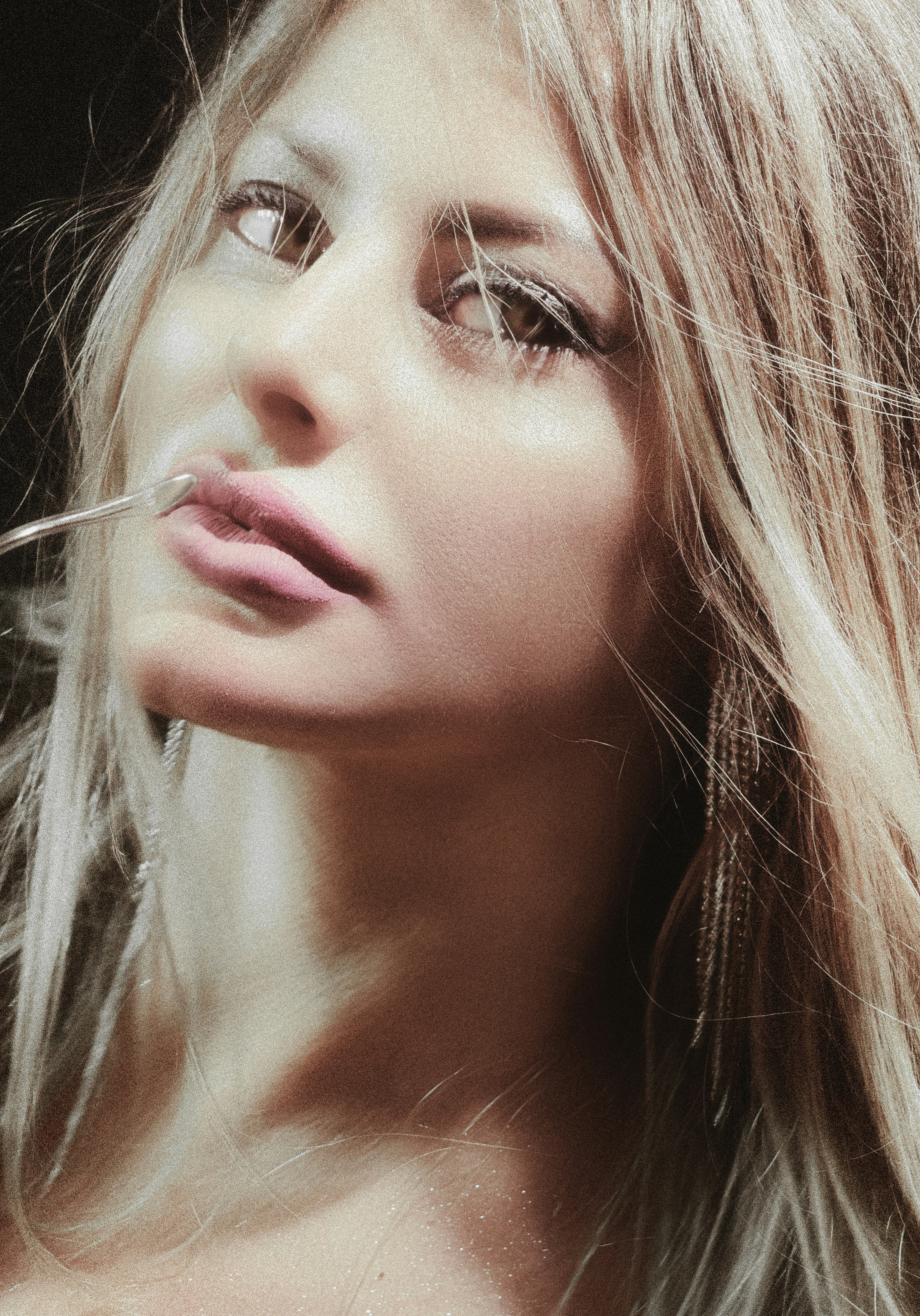 Close-up of a woman with blonde hair and makeup.