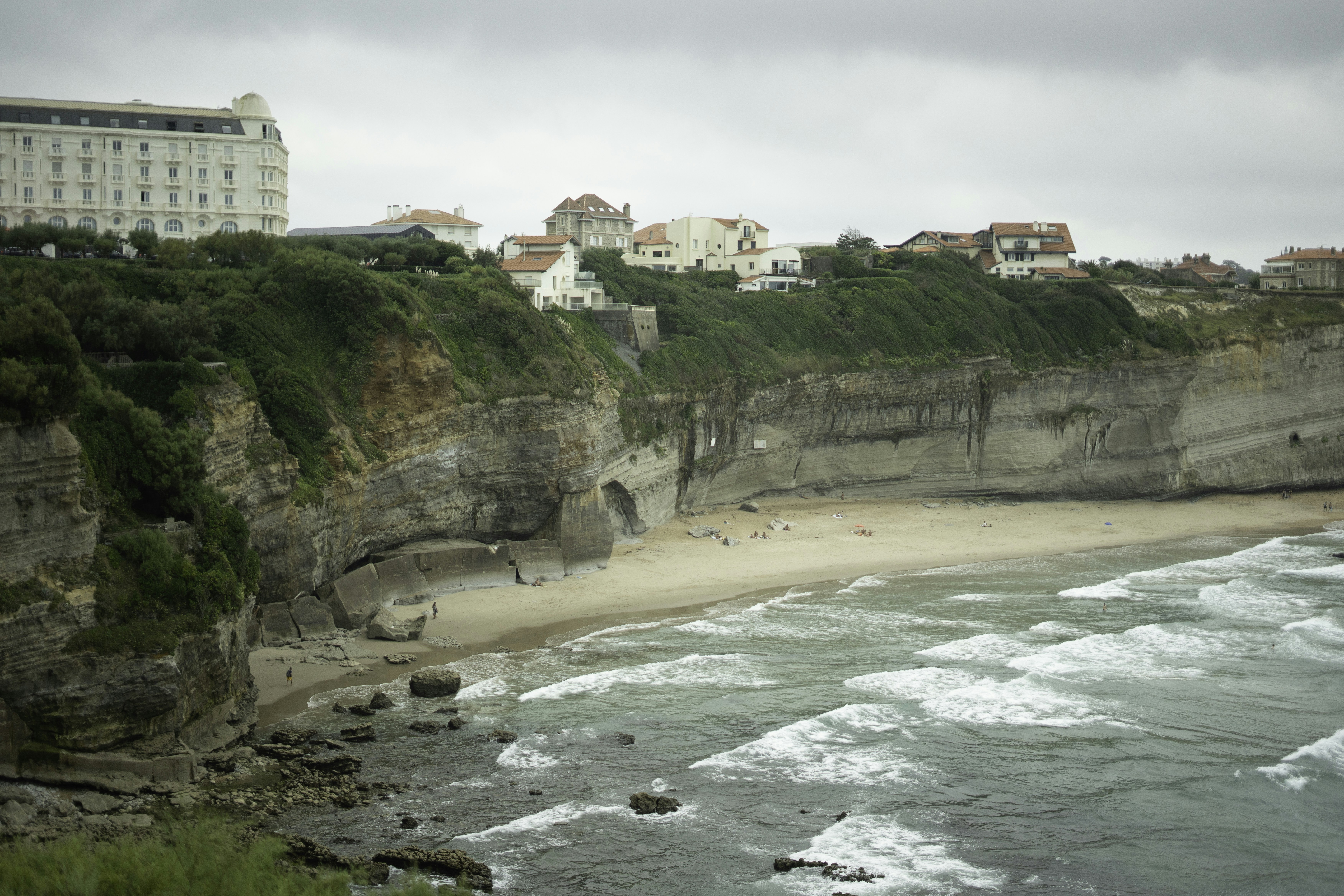 Coastal cliffs with a beach and buildings overlooking