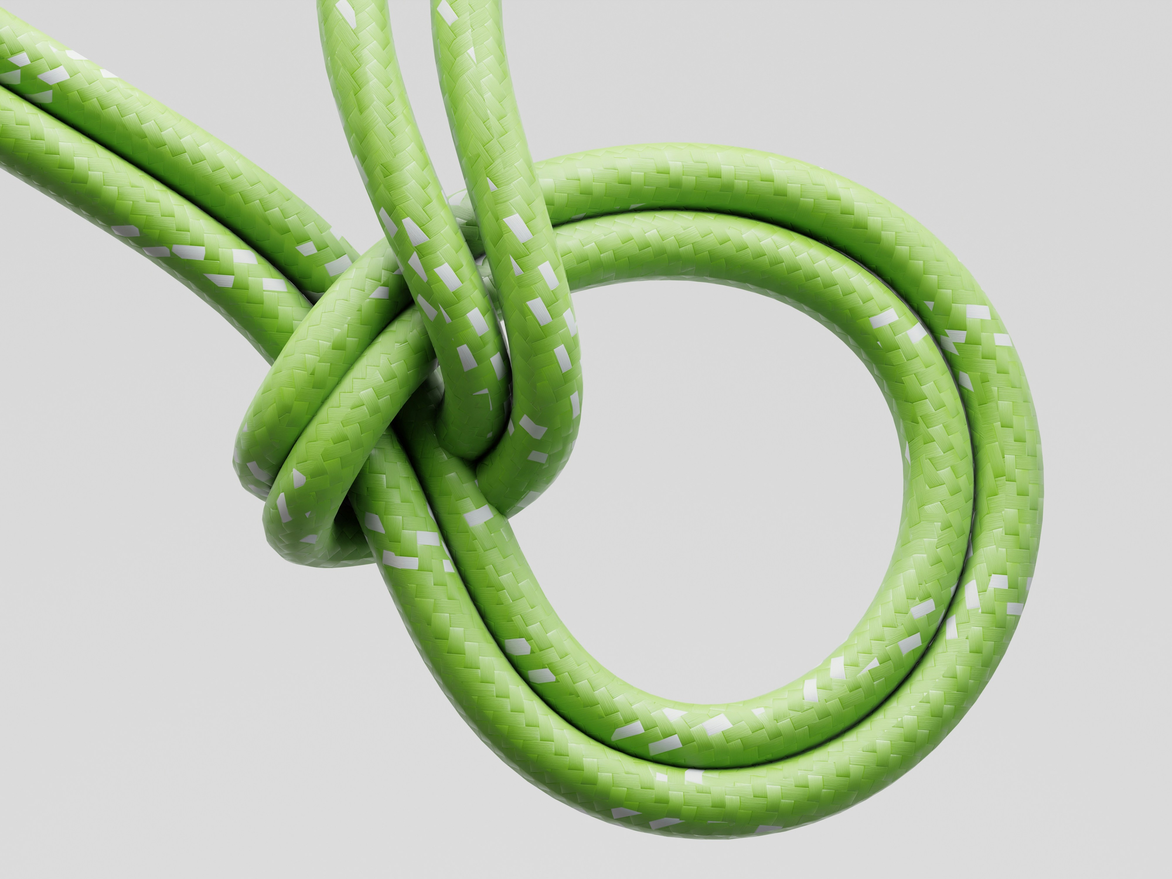 Green cord tied in a knot against white background
