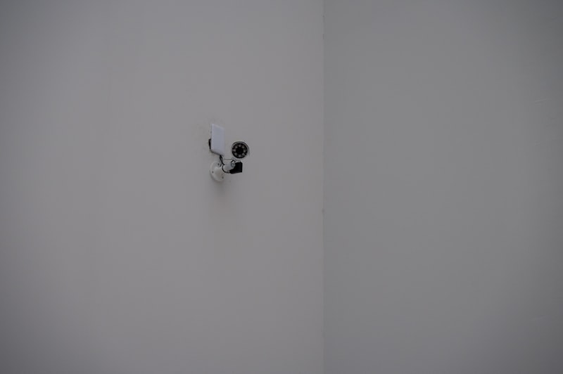 A security camera mounted in a white corner
