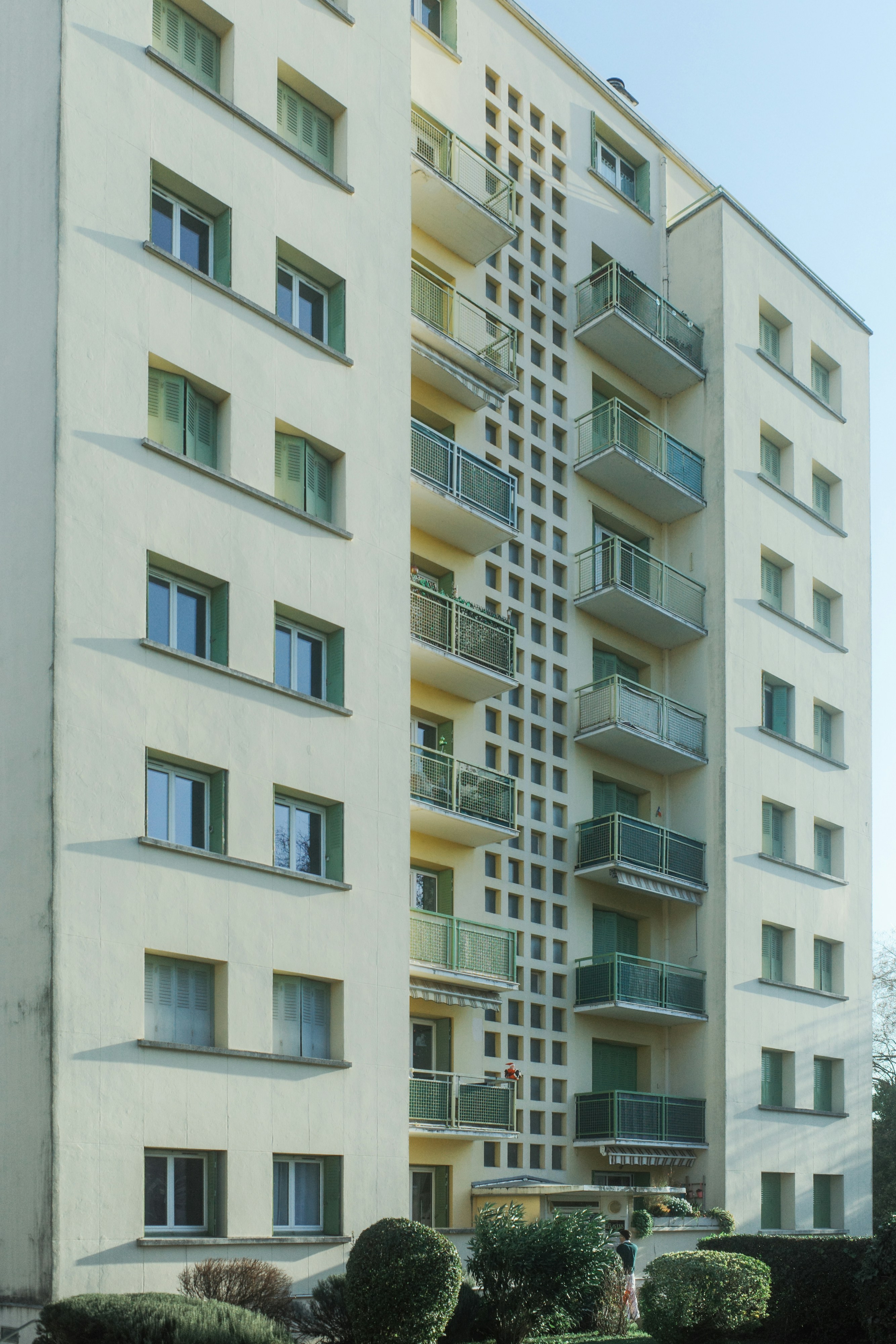 Tall cream-colored apartment building with balconies