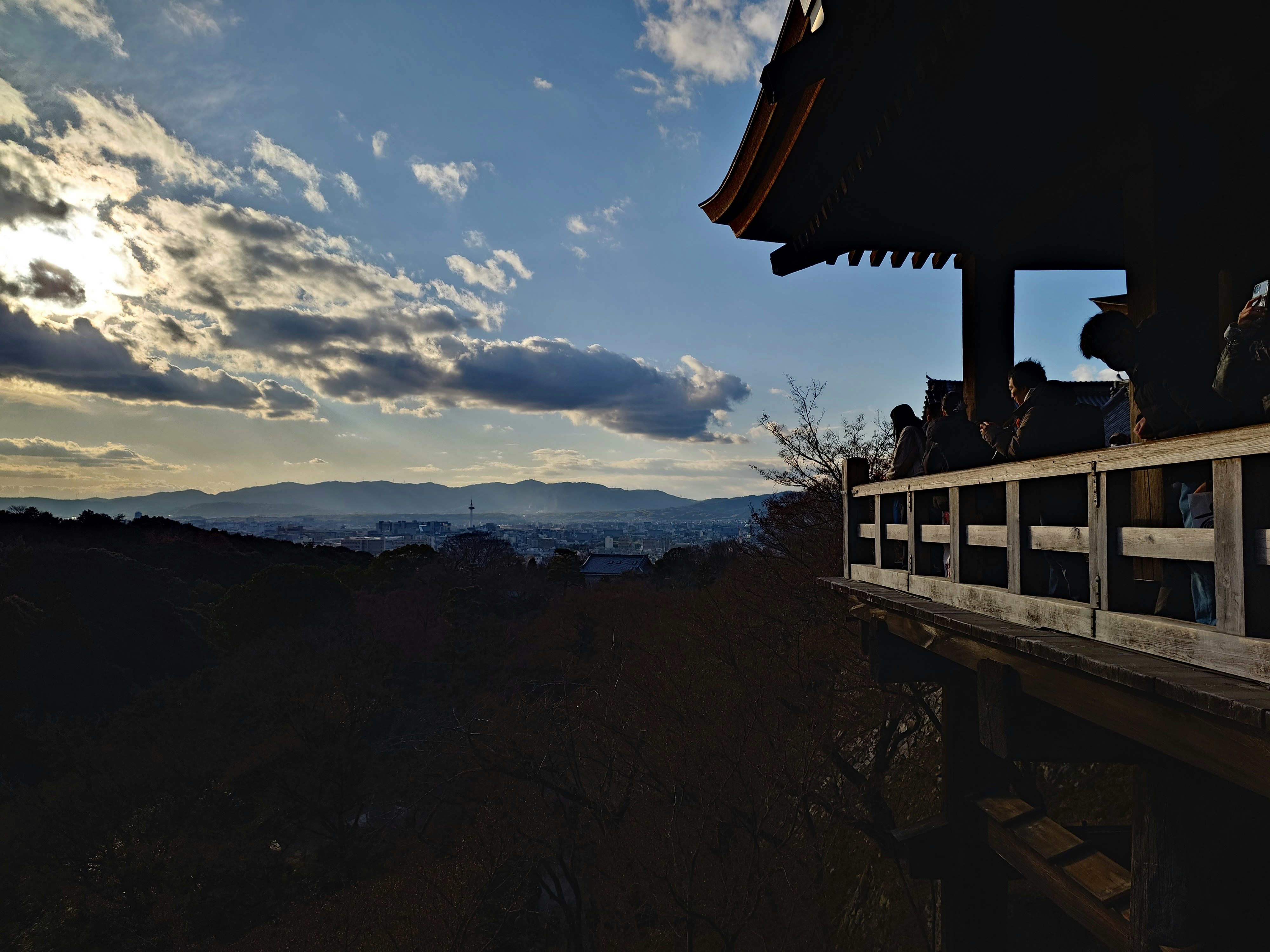 Temple balcony overlooking distant mountains at sunset