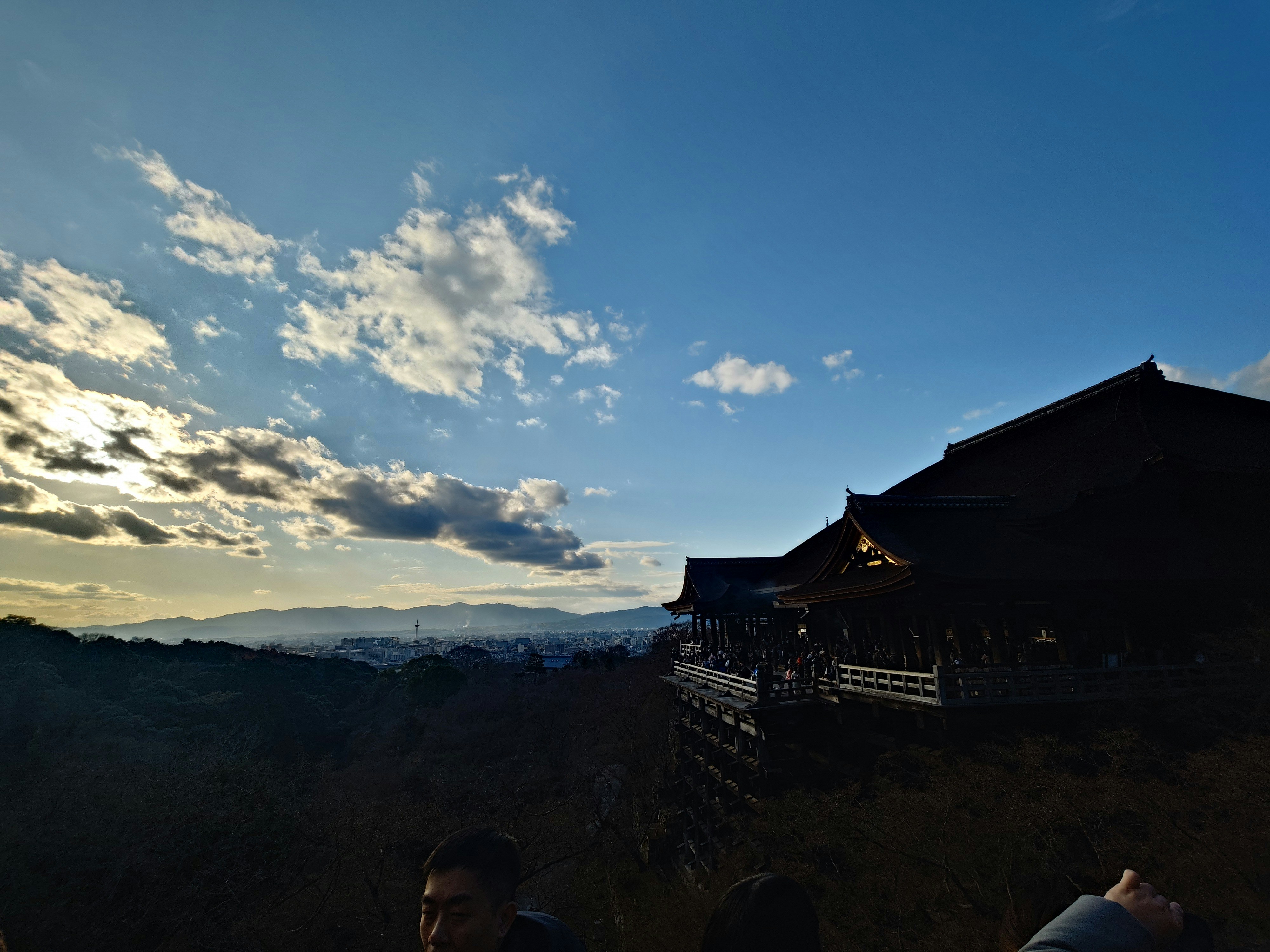 Traditional japanese temple structure against a sunset sky.