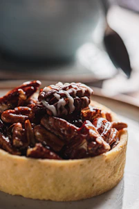 A close-up of a delicious pecan tart with caramel.