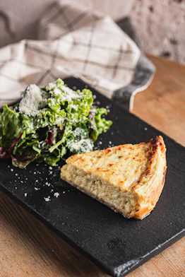 Slice of quiche with a side salad