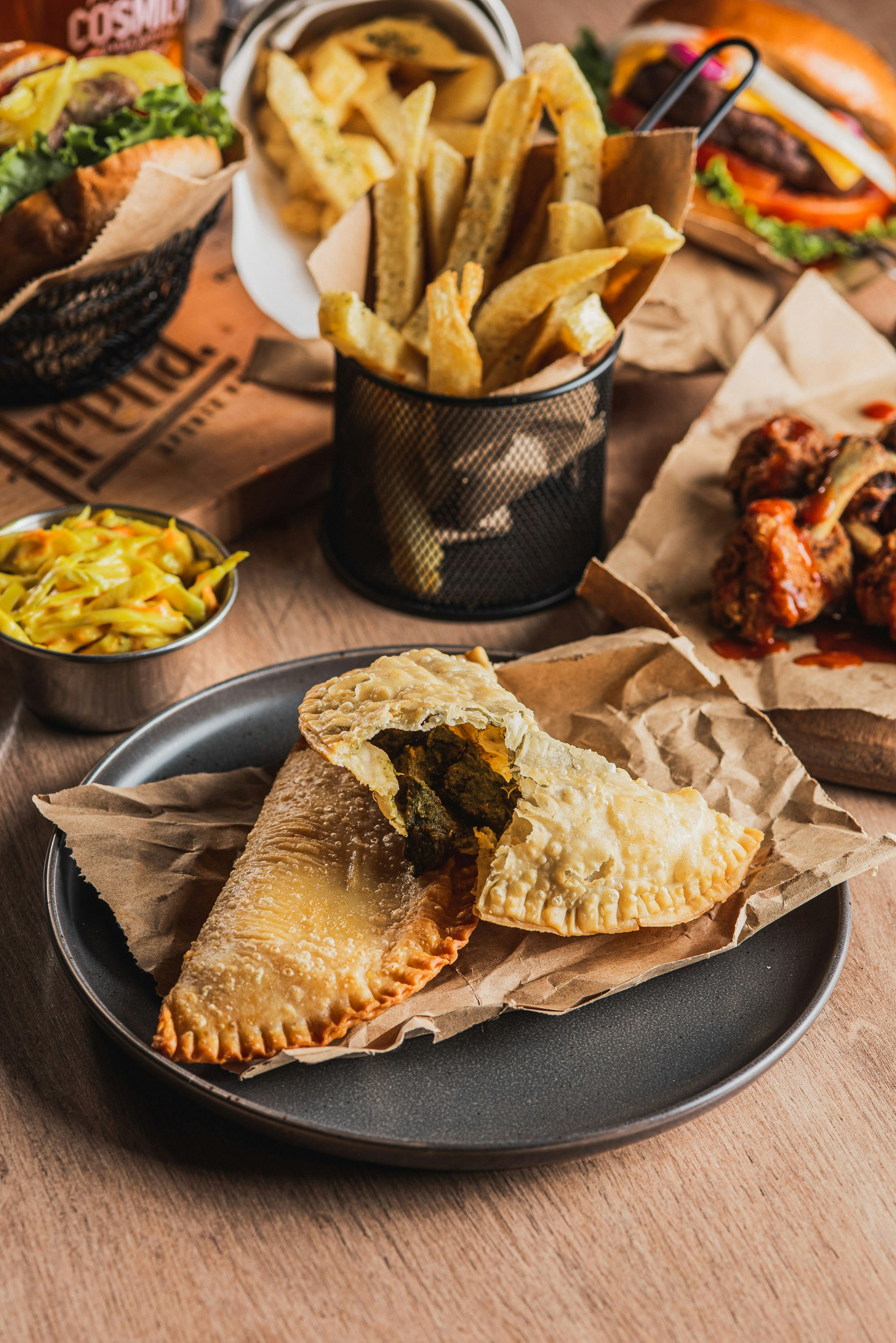 Empanadas with fries and coleslaw on table