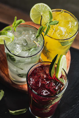 Three colorful cocktails with lime and mint