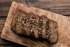 Sliced banana bread with nuts on a wooden board