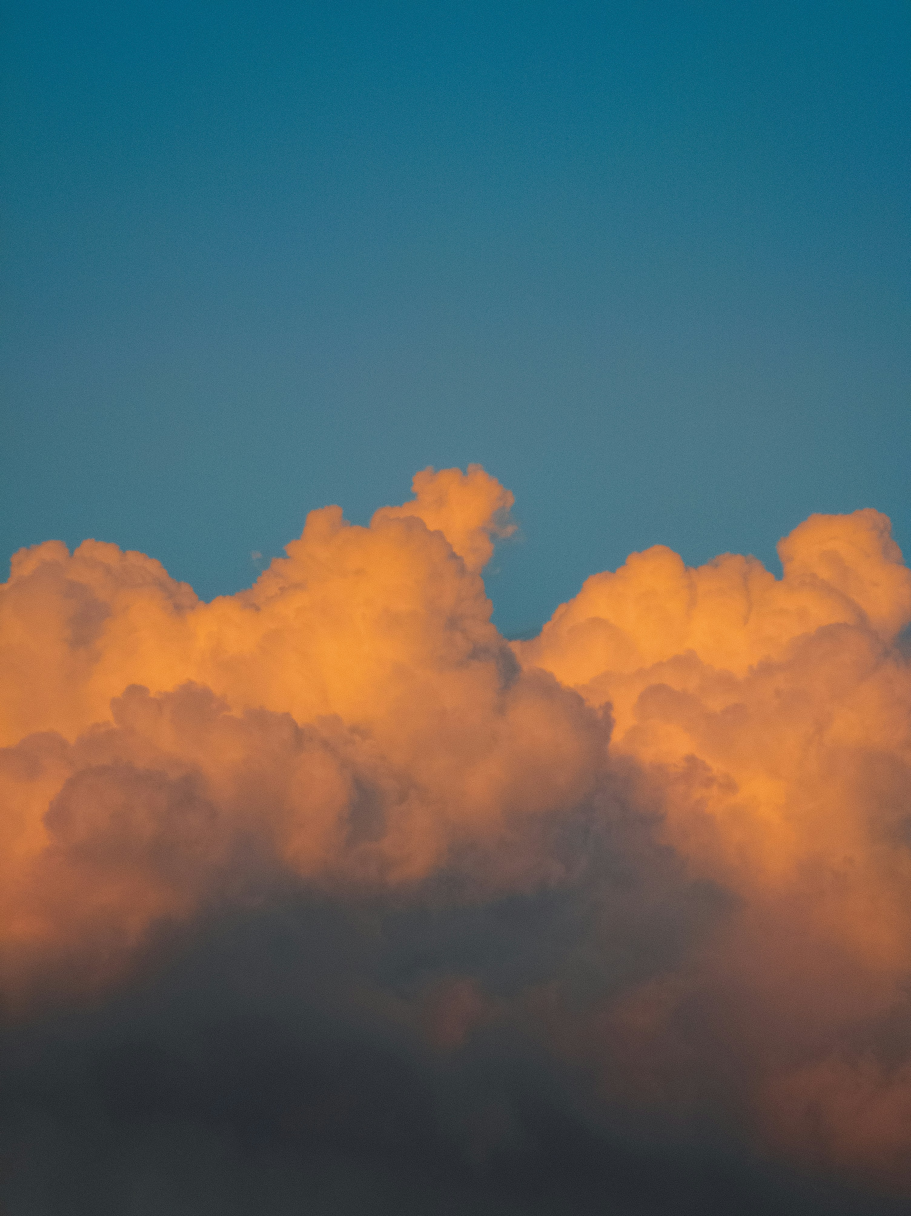 Golden clouds against a clear blue sky