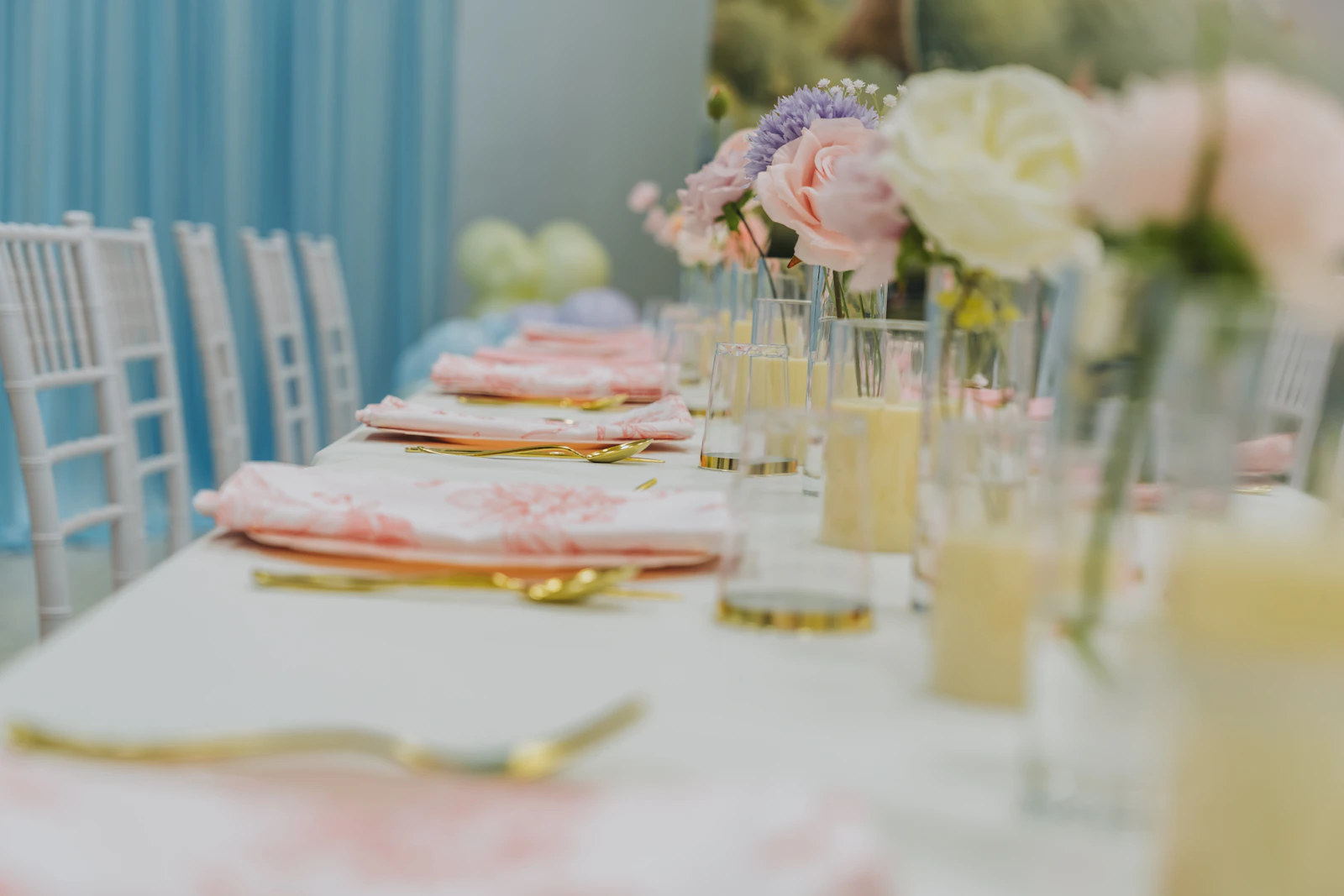 Styled event table with tableware napkins floral details balloons and coordinated celebration decor