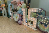 Illuminated number 15 decoration with balloons