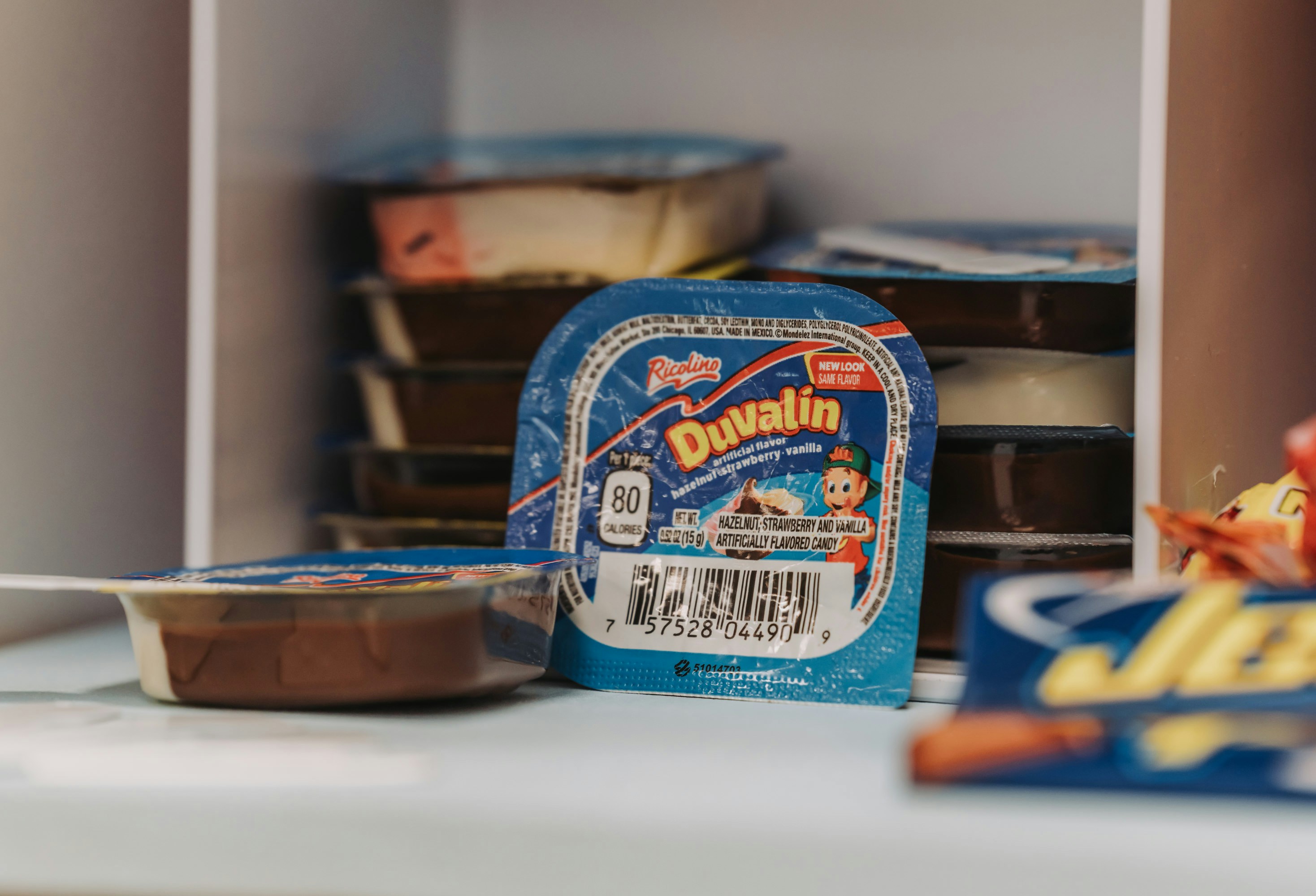 Stack of duvalin candy packages in a shelf.