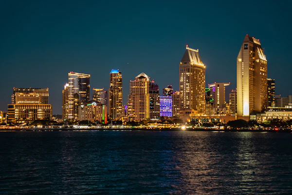 The San Diego skyline lit up over the bay at night