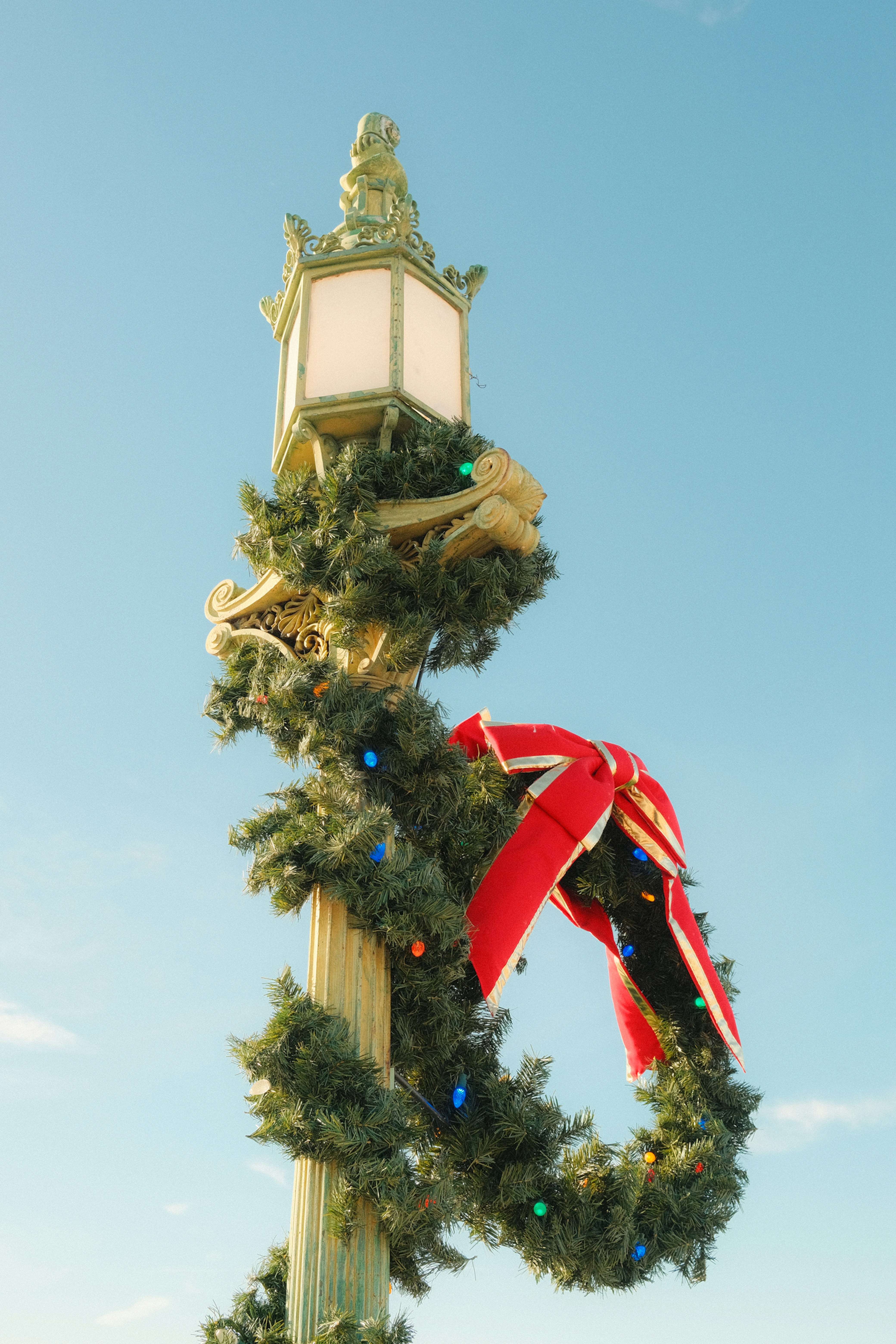 Street lamp decorated for christmas with garland and lights
