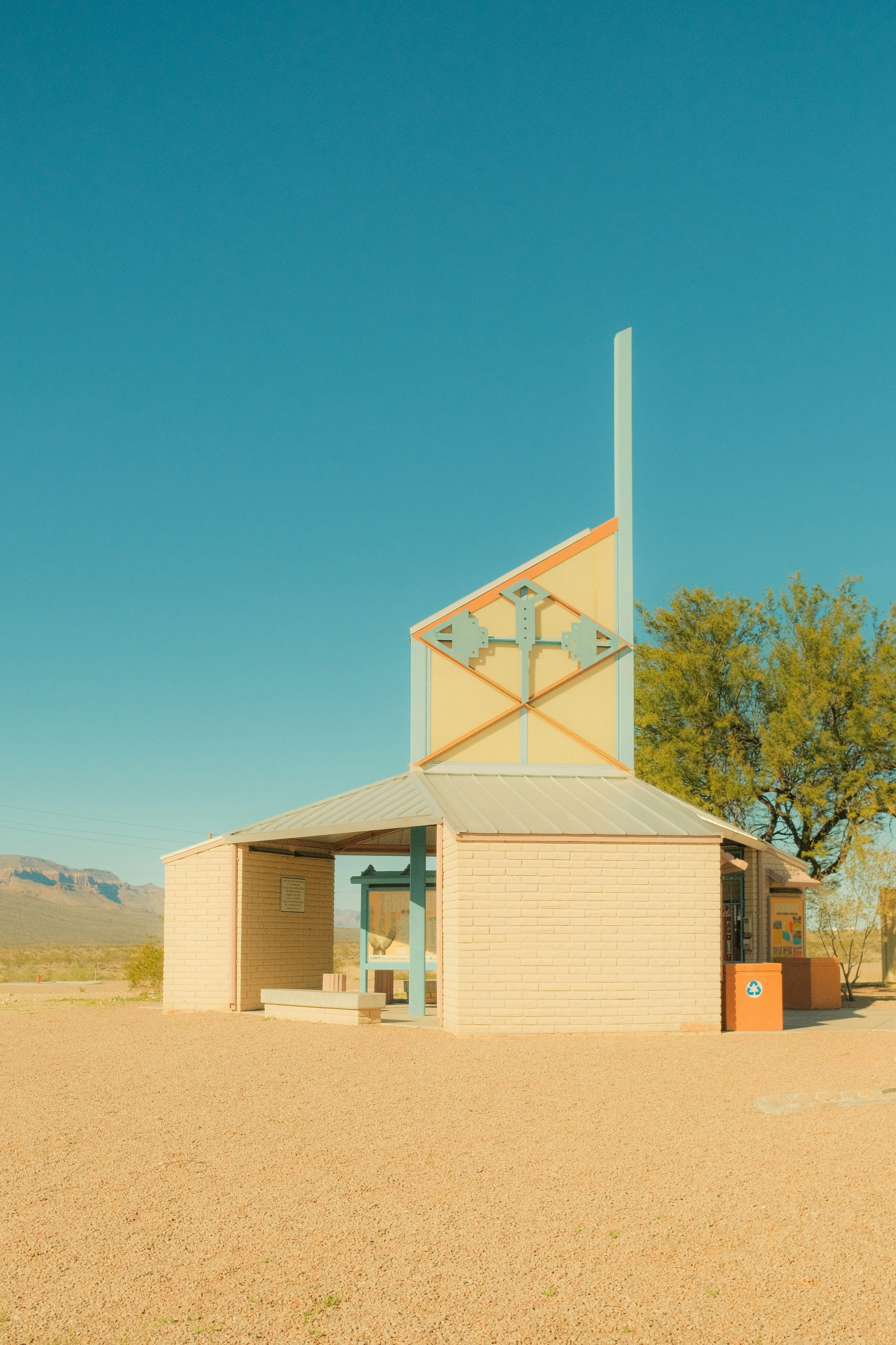 Modern desert chapel with a distinctive cross design.