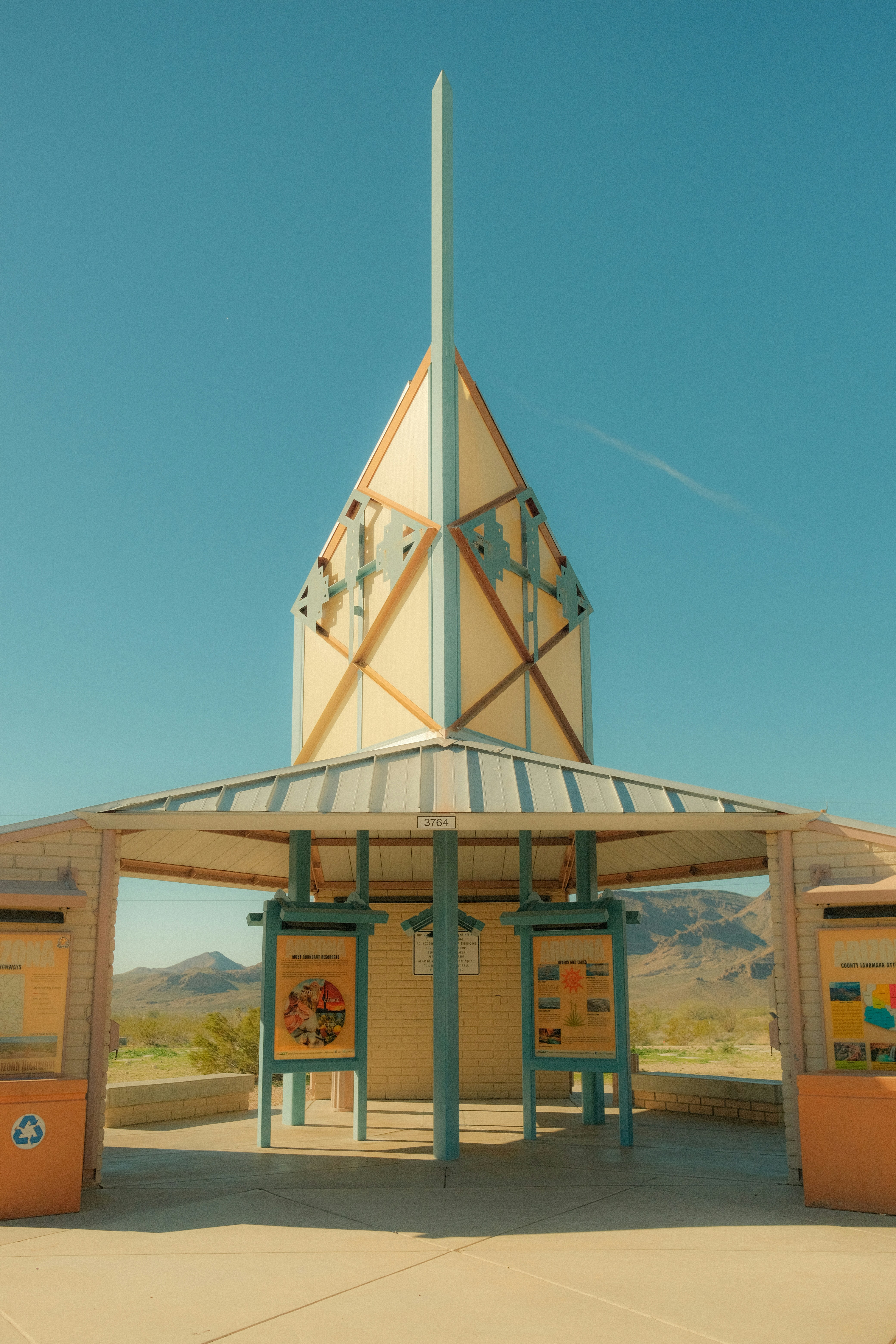 Modern structure with informational displays in desert landscape