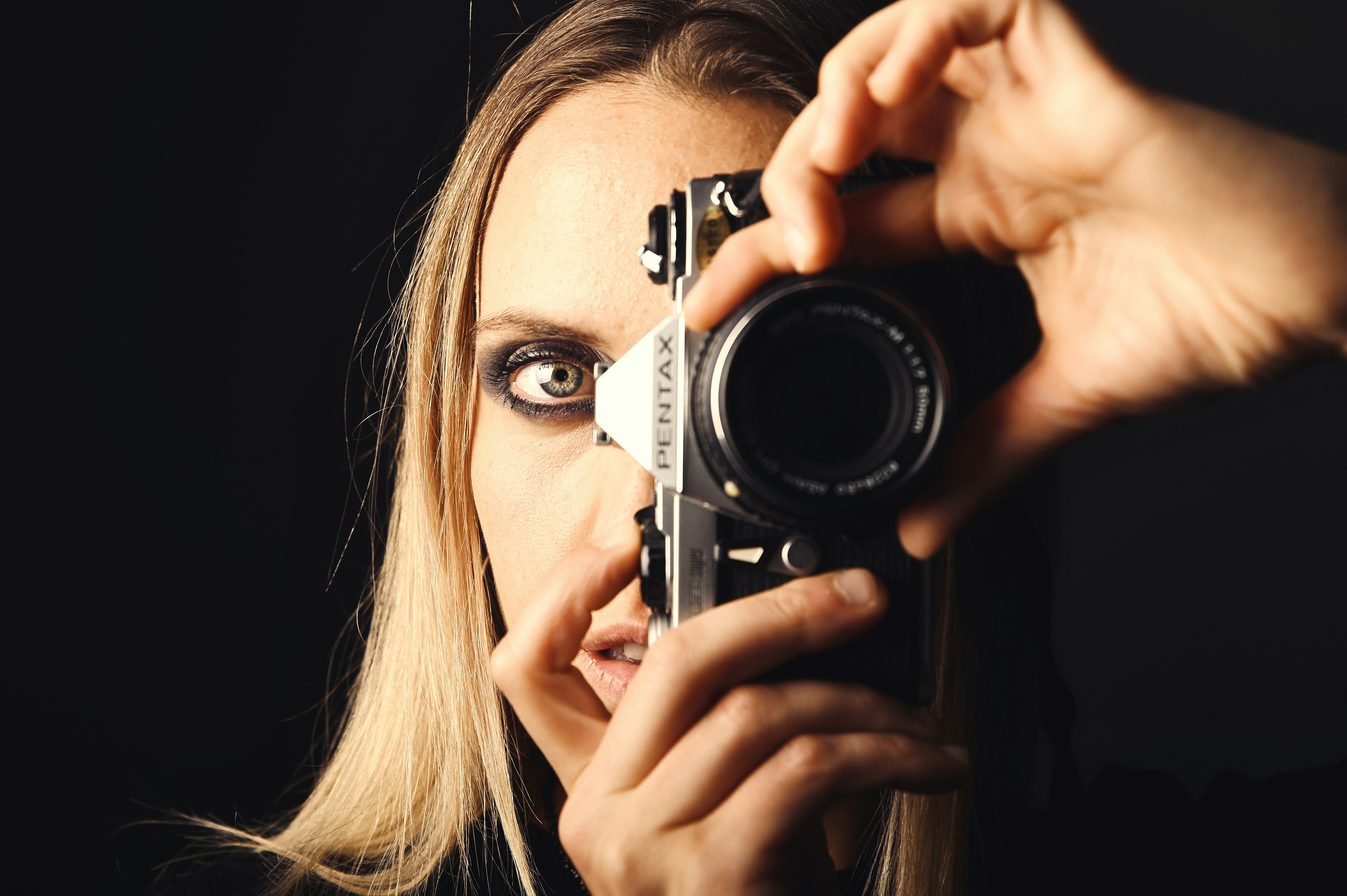 Woman holding a camera to her face