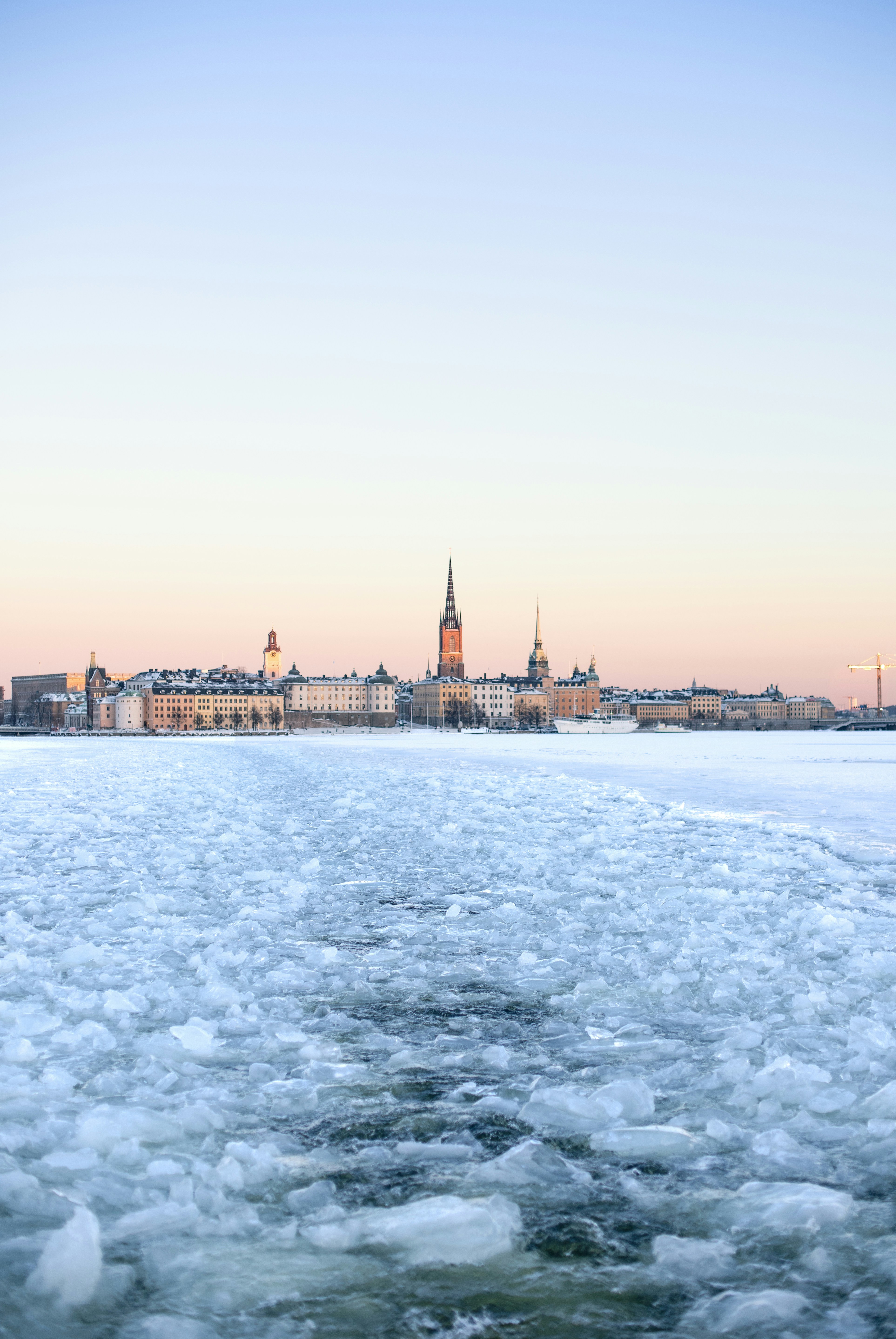 Frozen river with city skyline at dawn