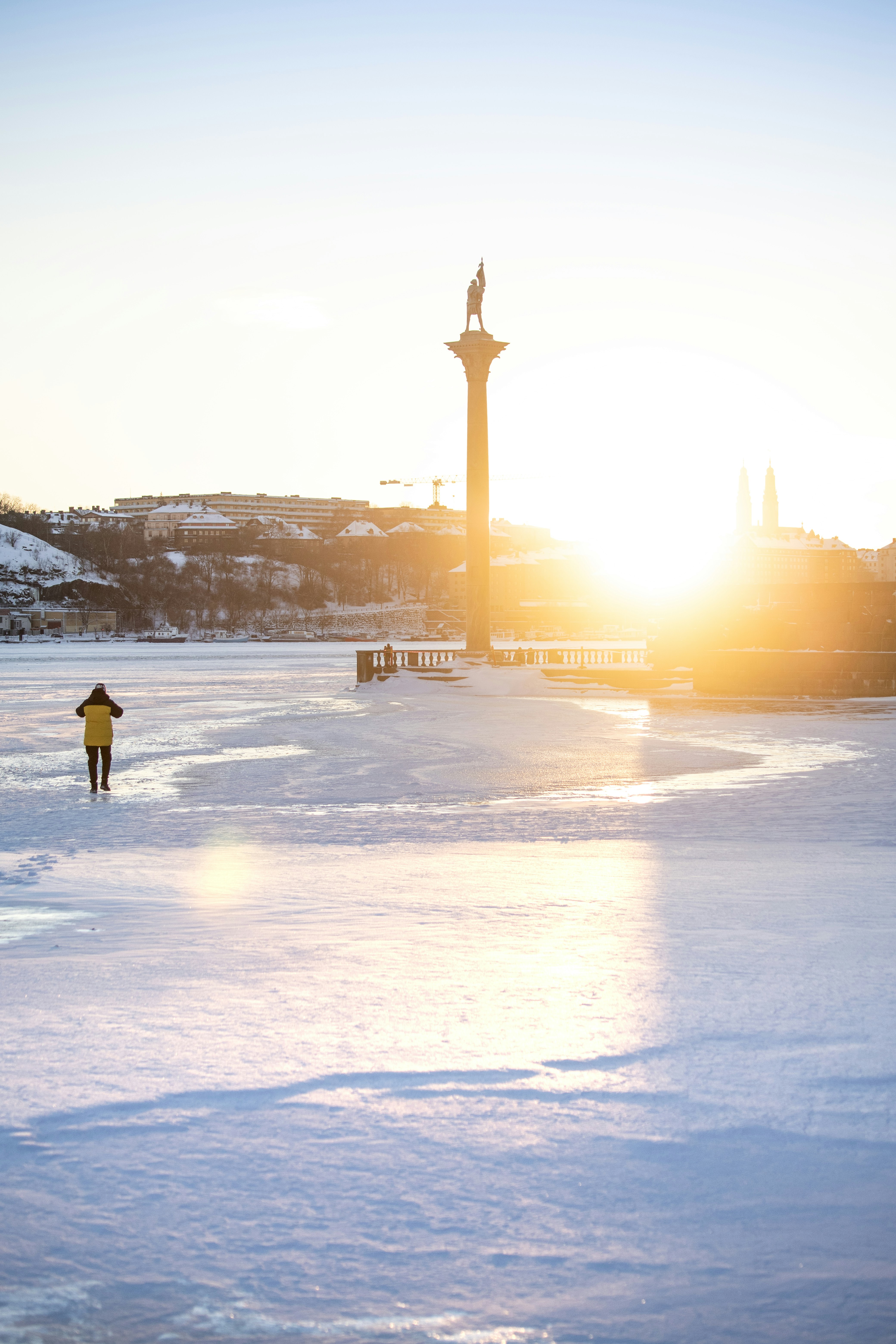 Person walks on frozen ground towards monument at monument.