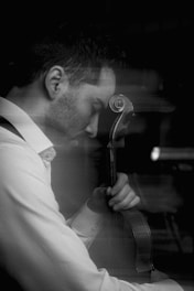 Man playing cello with eyes closed