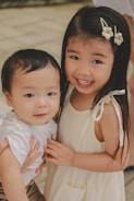 Two young children smiling at the camera.