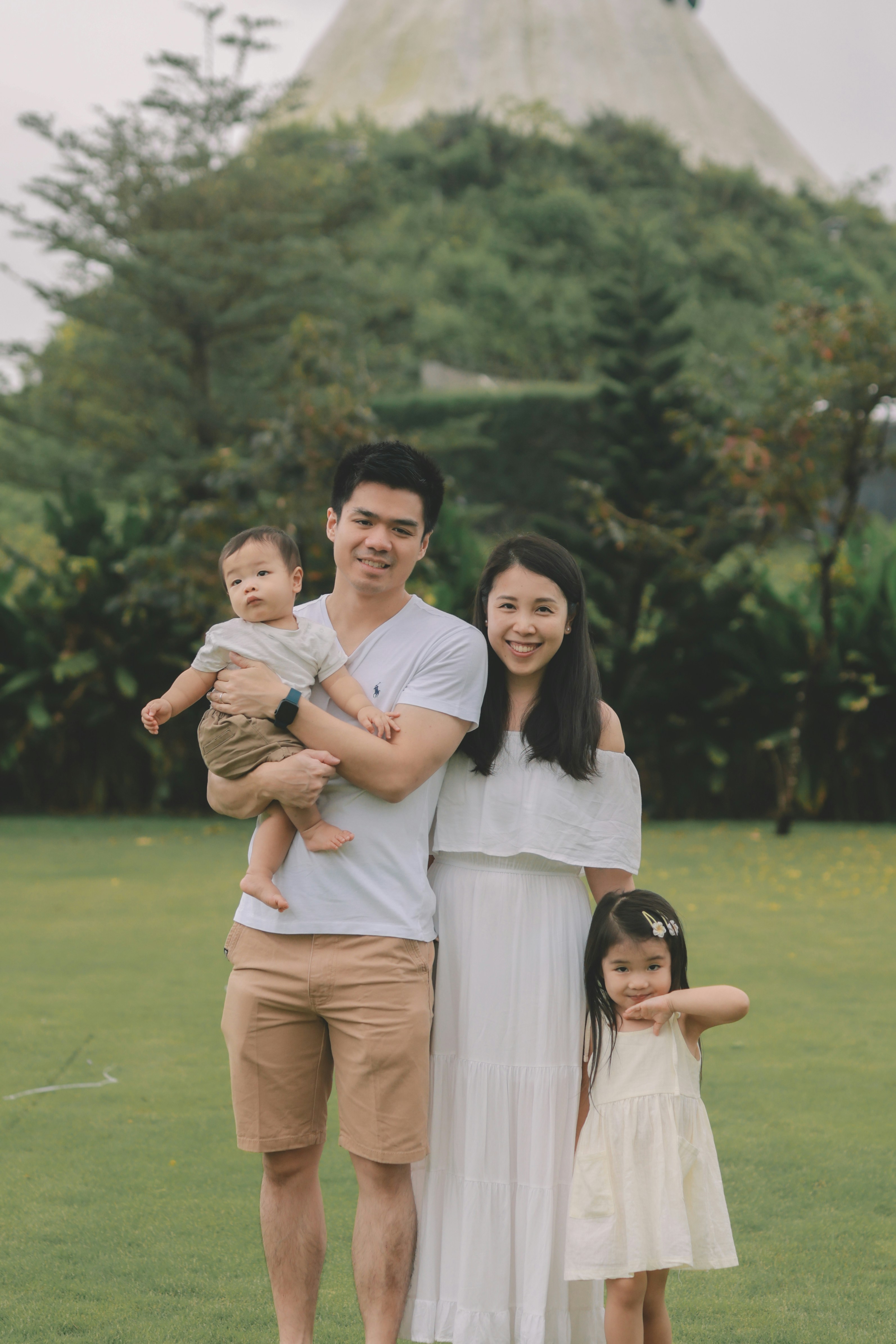 Family of four posing in a park